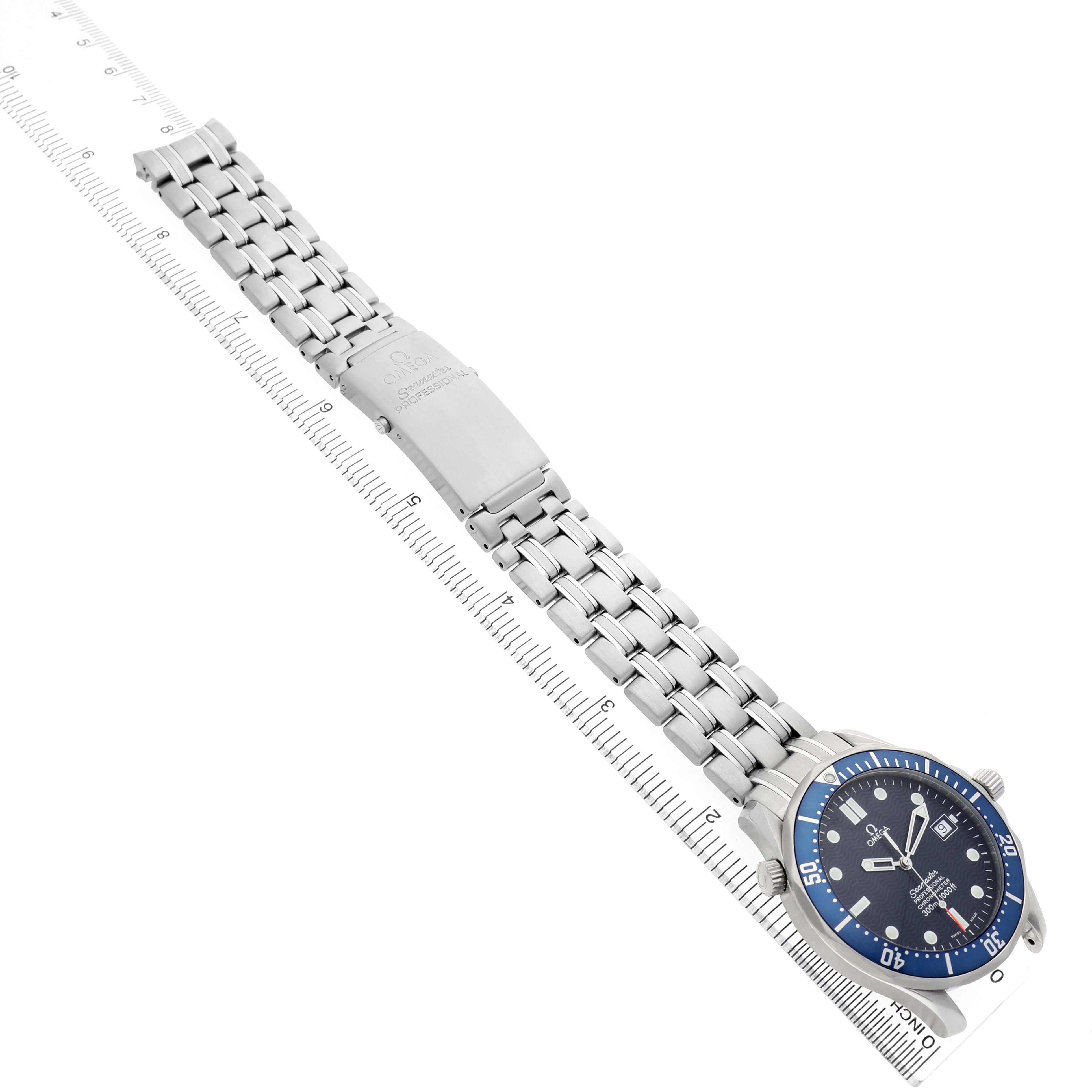 The Omega Seamaster 2531.80.00 Men's Stainless Steel Blue Dial watch is shown from a top angle, highlighting the full bracelet and clasp alongside a ruler for scale.