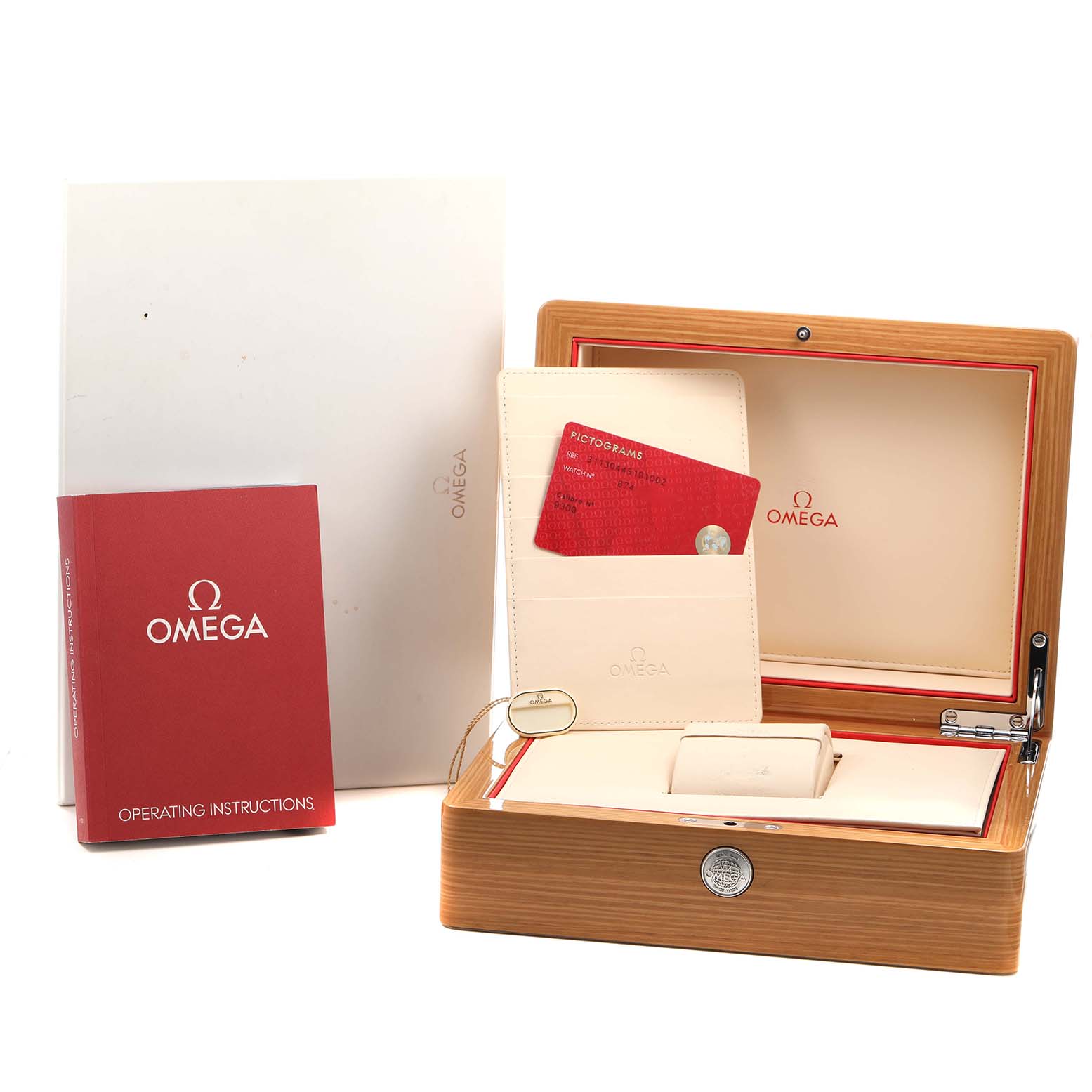 The image shows a wooden Omega Speedmaster 311.30.44.51.01.002 Men's Stainless Steel Black Dial watch box, instruction manual, warranty card, and additional documentation.