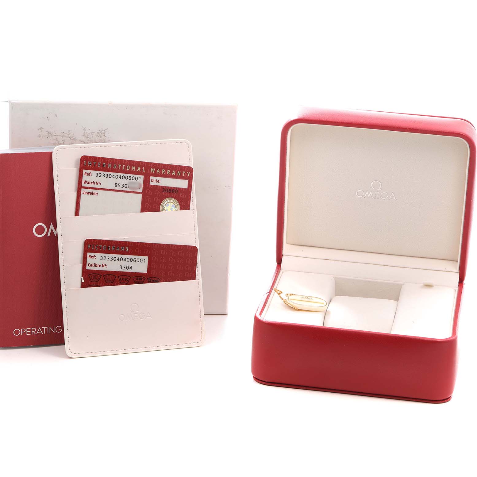 The image shows Omega Speedmaster 323.30.40.40.06.001 Men's Stainless Steel Grey Dial packaging, including an open red watch box, warranty cards, and an operating manual.