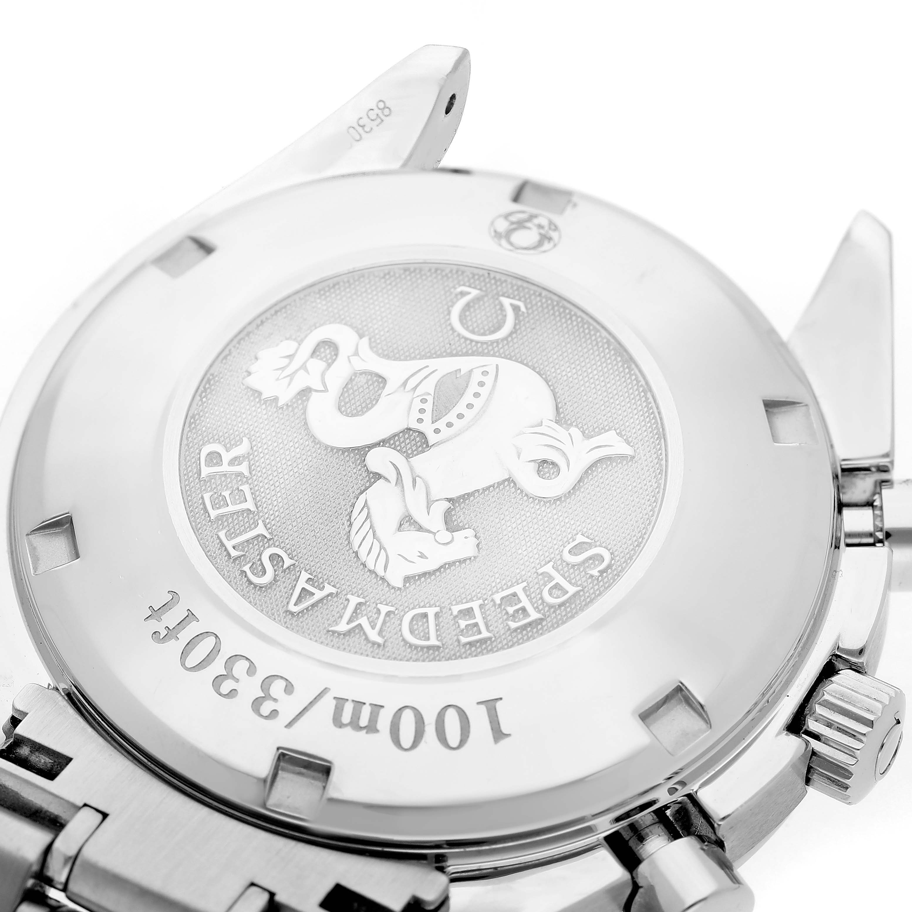 The image shows the back casing of an Omega Speedmaster 323.30.40.40.06.001 Men's Stainless Steel Grey Dial watch, highlighting the engraved emblem and text.