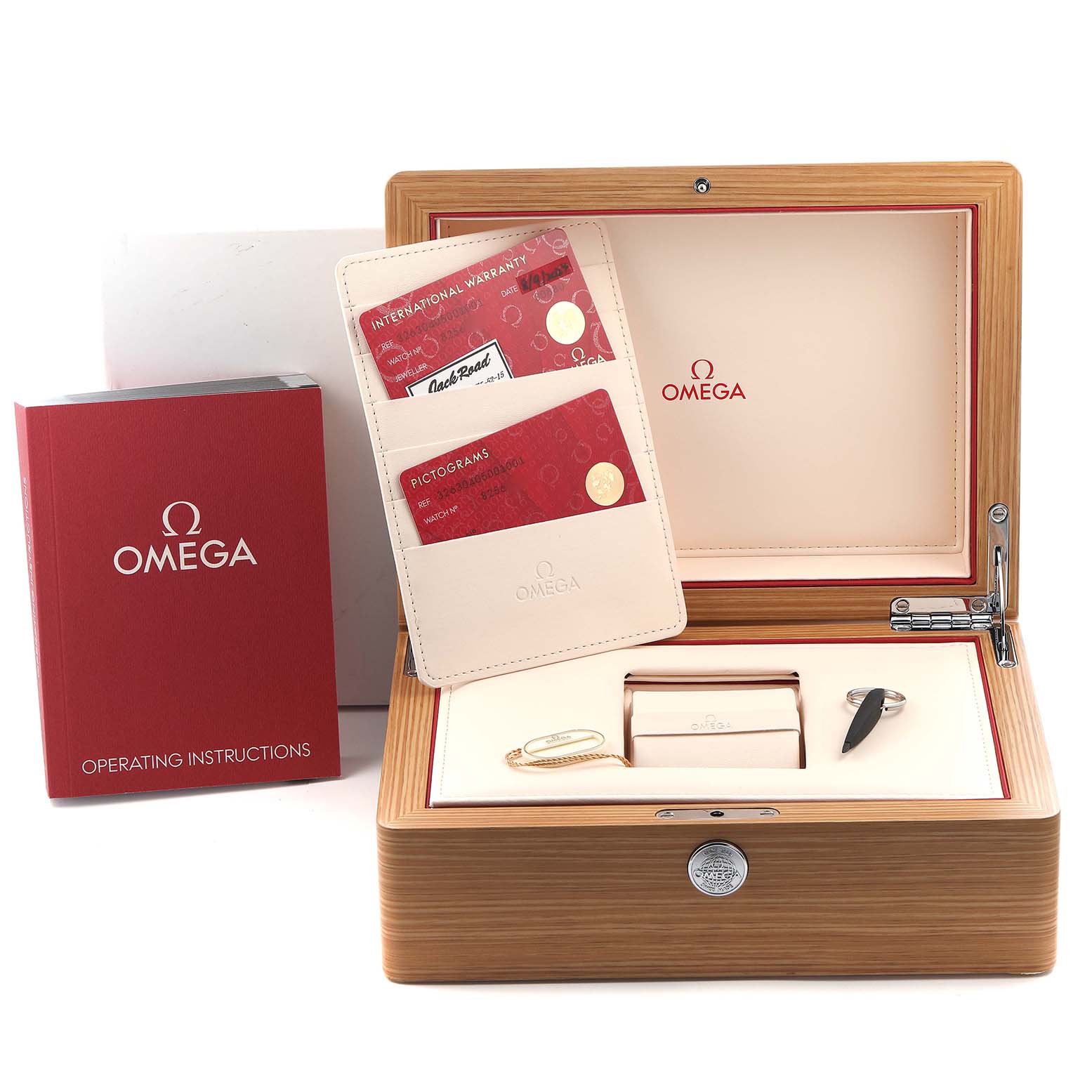 The image shows an Omega Speedmaster 326.30.40.50.01.001 Men
s Stainless Steel Black Dial 326.30.40.50.01.001 Men
s Stainless Steel Black Dial box set with certificates, a tool, and a key, viewed from the top.