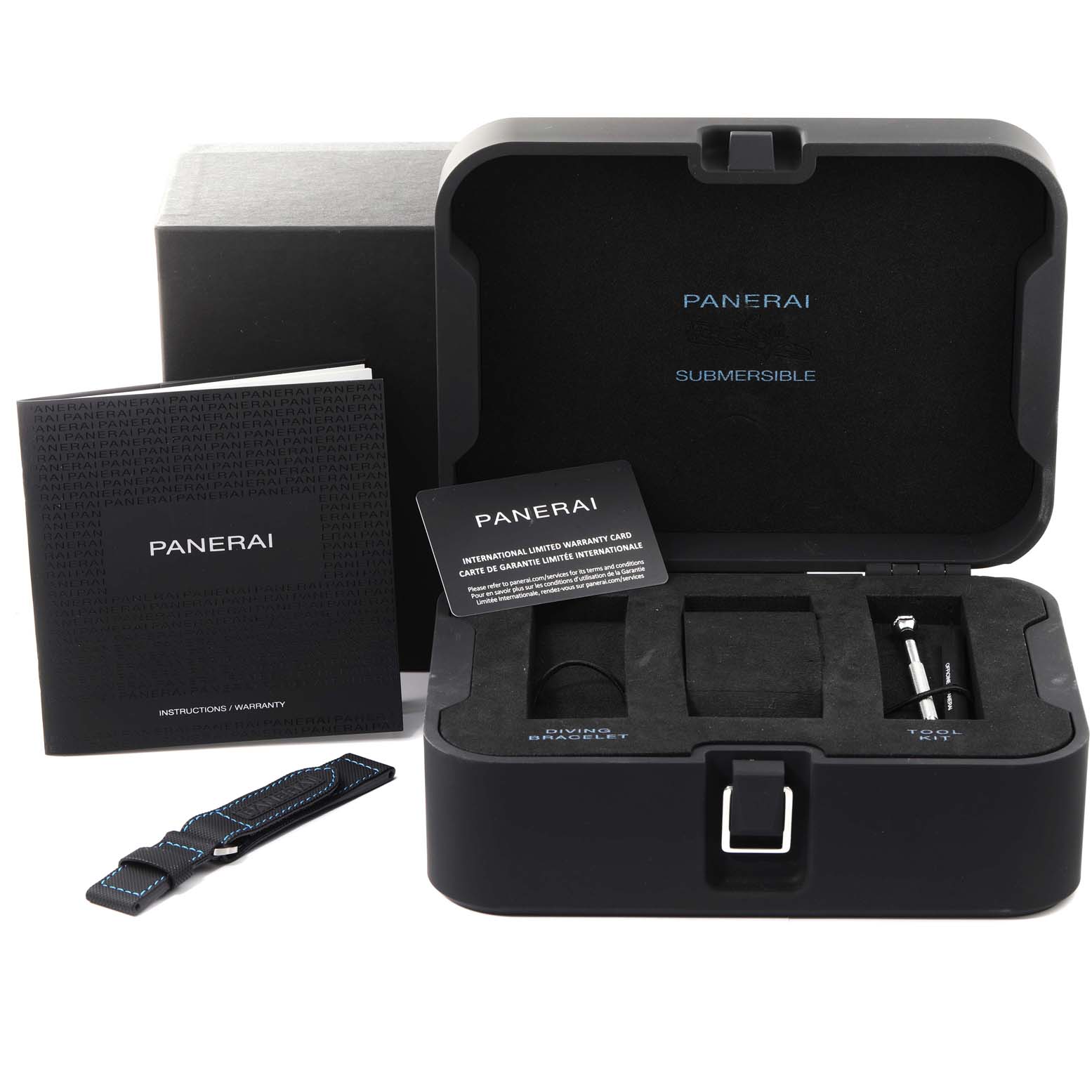 Shown is the open box of the Panerai Submersible PAM00973 Men's Stainless Steel Black Dial PAM00973 Men's Stainless Steel Black Dial, highlighting the instruction booklet, warranty card, additional strap, and tool kit.
