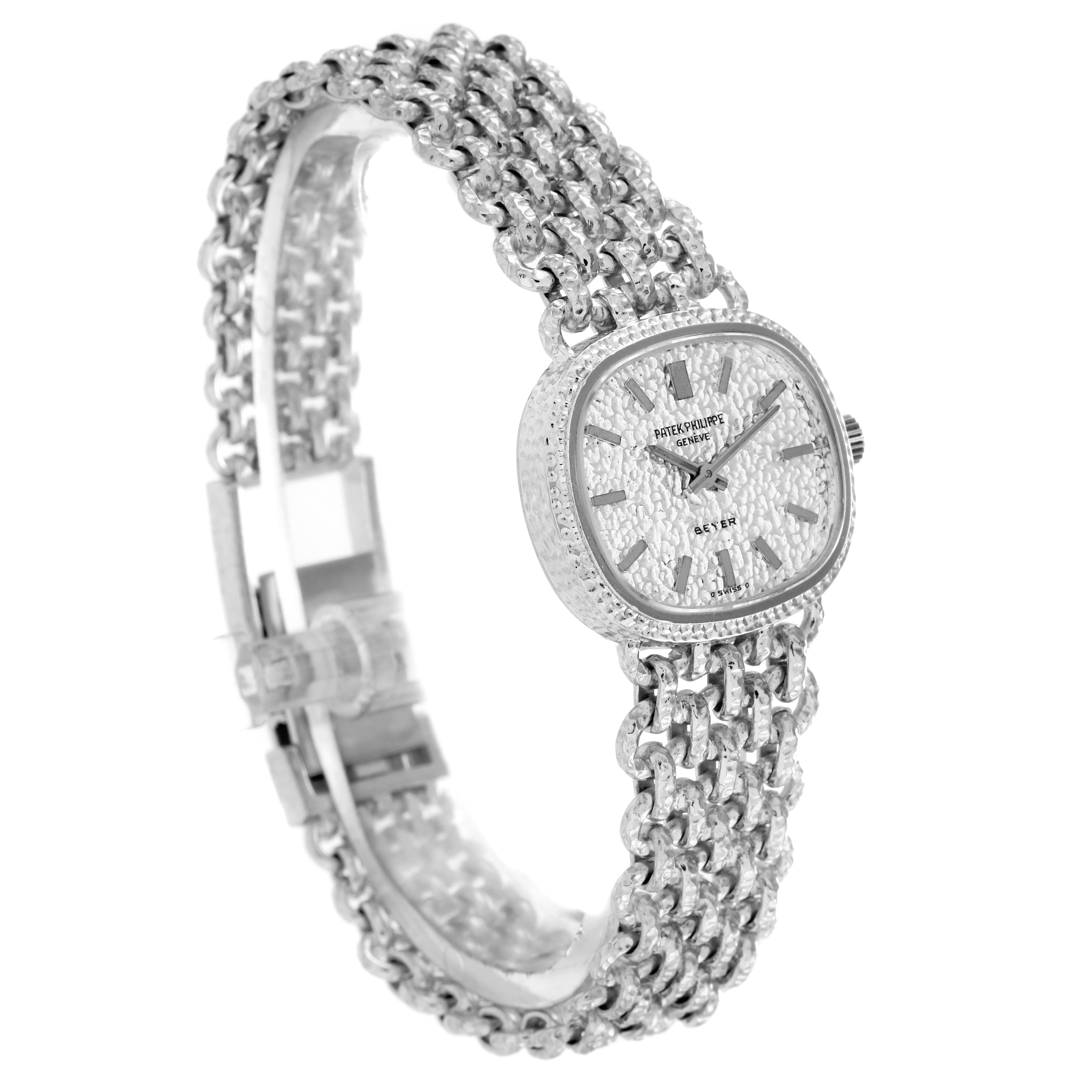 The Patek Philippe Golden Ellipse 4133 Women's White Gold White Dial 4133 Women's White Gold White Dial watch is shown at a three-quarter angle, displaying the face and textured band.