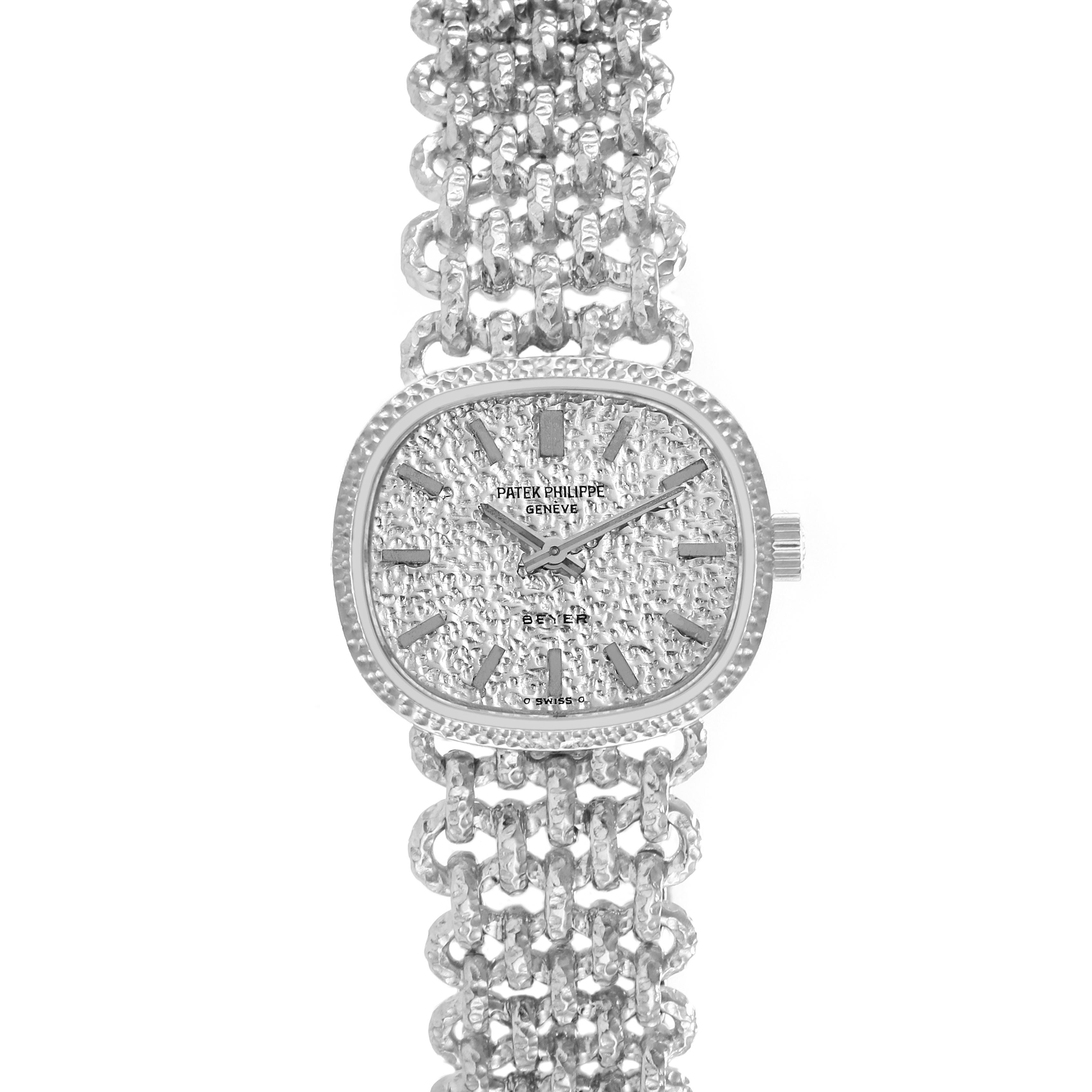 The Patek Philippe Golden Ellipse 4133 Women's White Gold White Dial 4133 Women's White Gold White Dial watch is shown from a top-down angle, displaying its textured dial and linked bracelet.