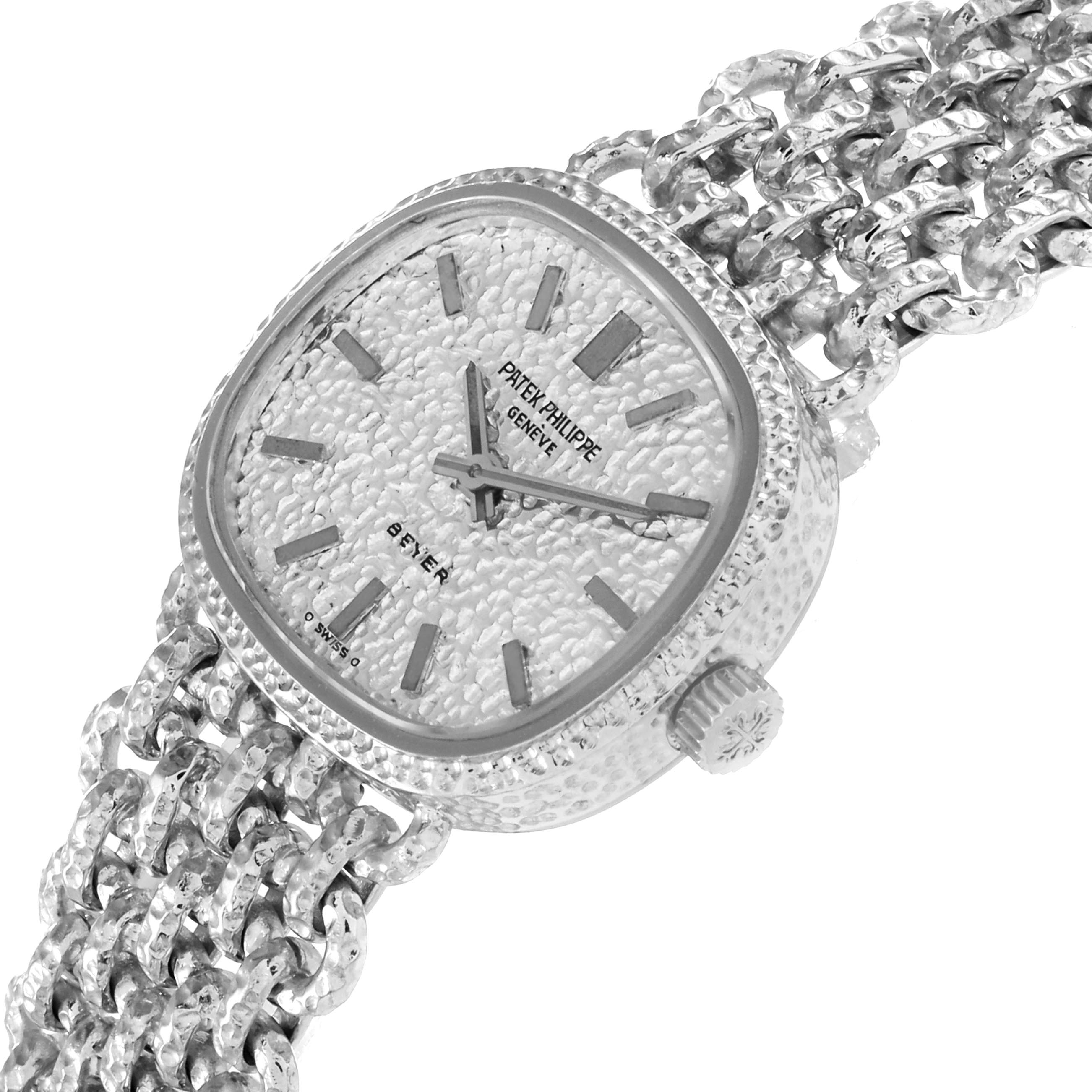 The image shows a Patek Philippe Golden Ellipse 4133 Women's White Gold White Dial 4133 Women's White Gold White Dial watch at a tilted angle, displaying the face, crown, and textured bracelet.