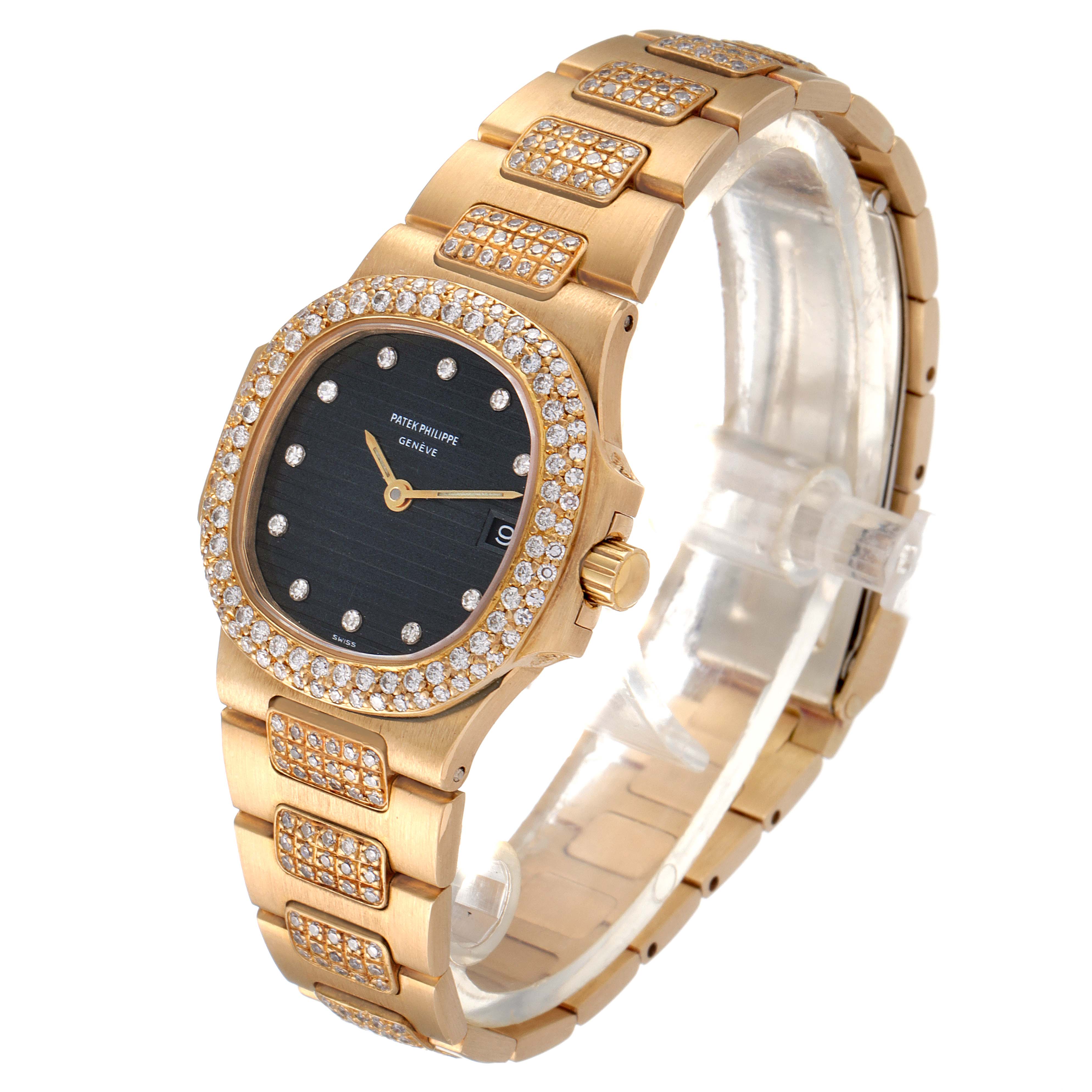 The Patek Philippe Nautilus 4700/G Women's Yellow Gold Black Dial 4700/G Women's Yellow Gold Black Dial watch is shown at a slight angle, highlighting its gold band, black dial, and diamond-studded bezel and links.
