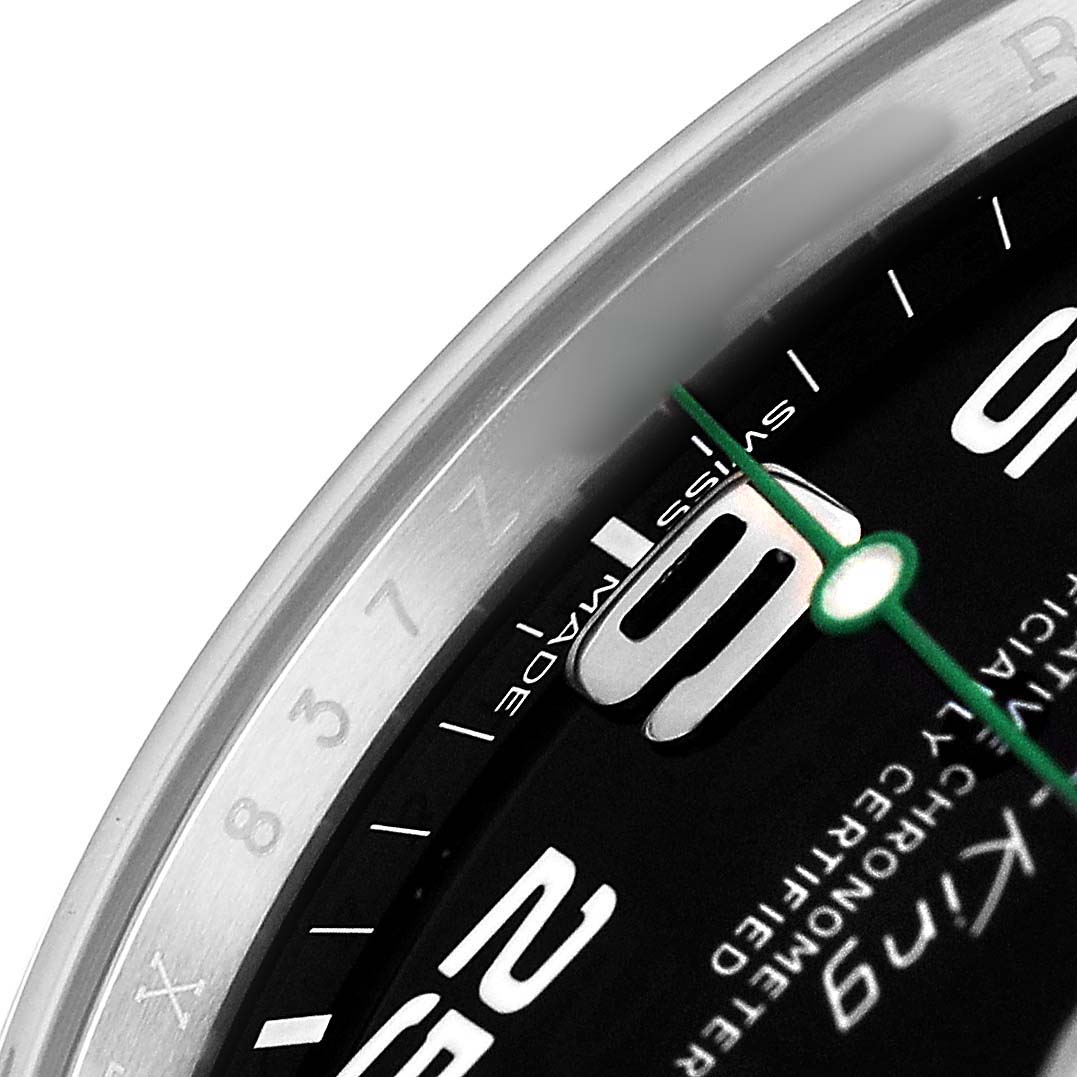 This image shows a close-up of the Rolex Air-King 116900 Men's Stainless Steel Black Dial's bezel, numerals, and minute hand at an angled view.