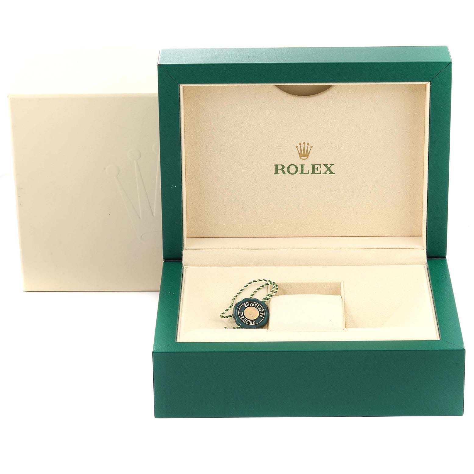 The image shows an open green and beige Rolex box for the Daytona model, including a tag and cushion but no watch.