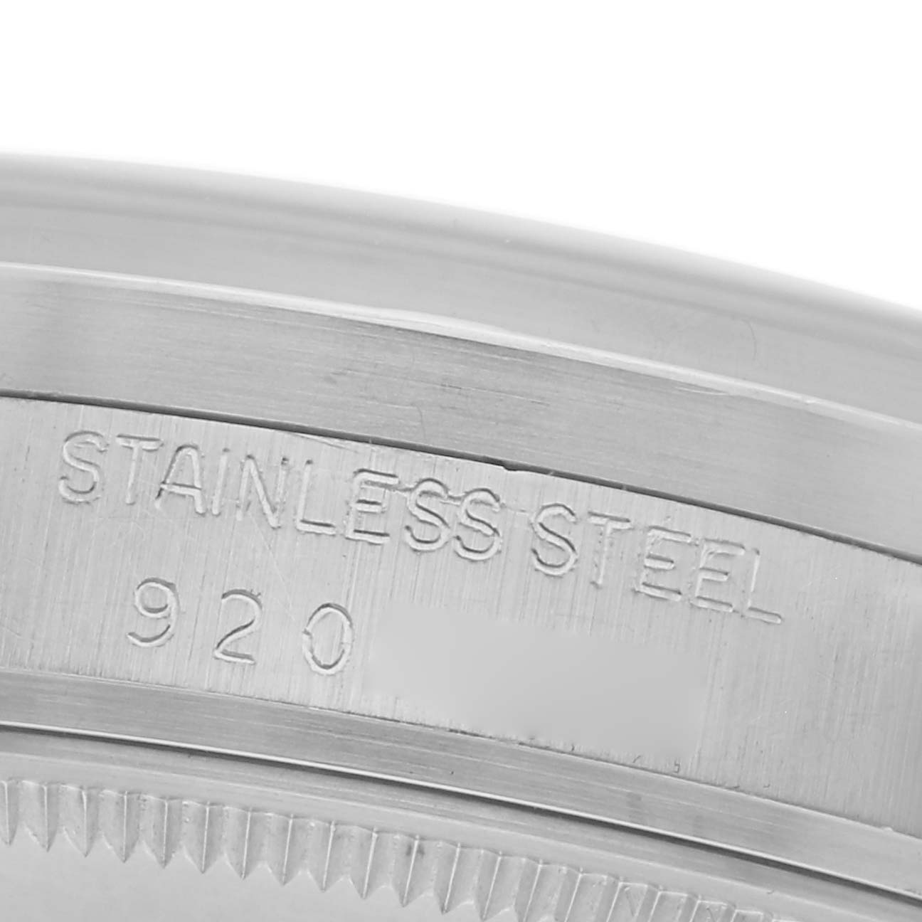 The image shows a close-up of the stainless steel case with engravings for the Rolex Date 15010 Men's Stainless Steel Silver Dial 15010 Men's Stainless Steel Silver Dial model.