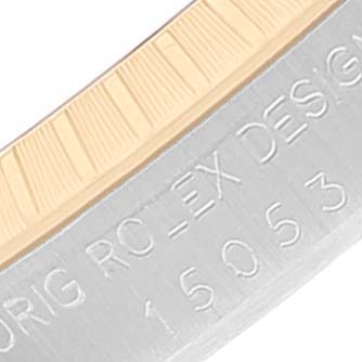 This image shows a close-up of the Rolex Date 15053 Men's Steel and Gold (two tone) Champagne Dial 15053 Men's Steel and Gold (two tone) Champagne Dial model's bezel, featuring its fluted texture and engraved serial number.