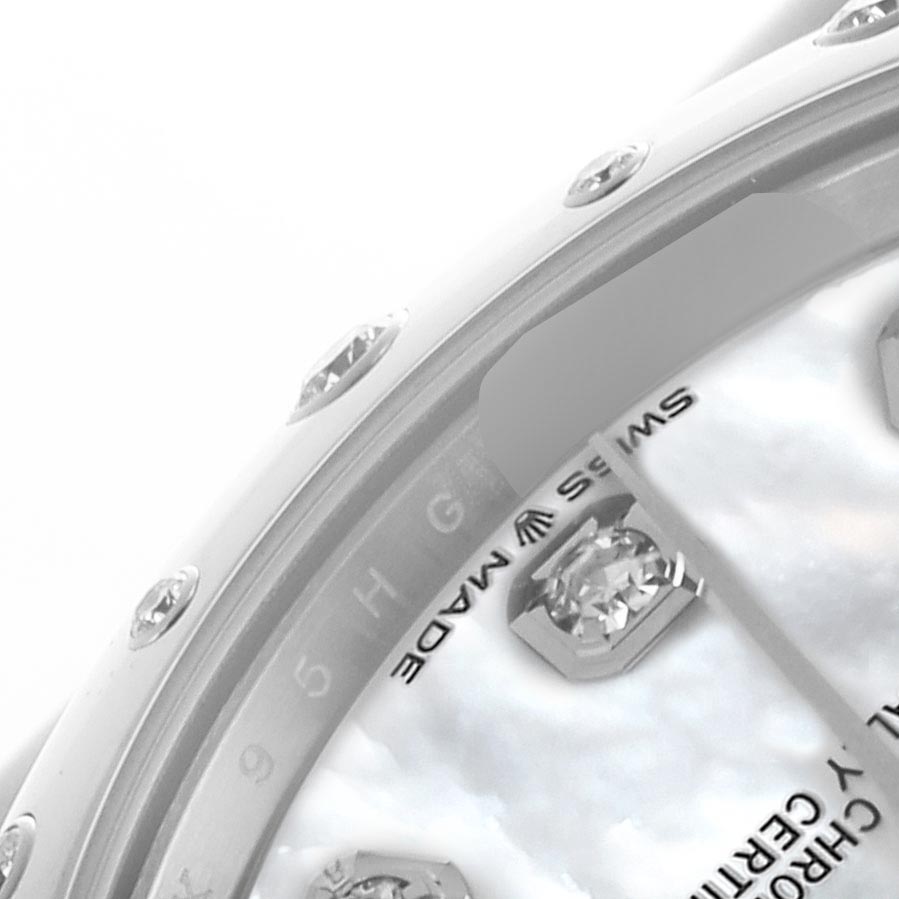 The image shows a close-up of the Rolex Datejust
s bezel with diamonds and part of the dial with text and indices.