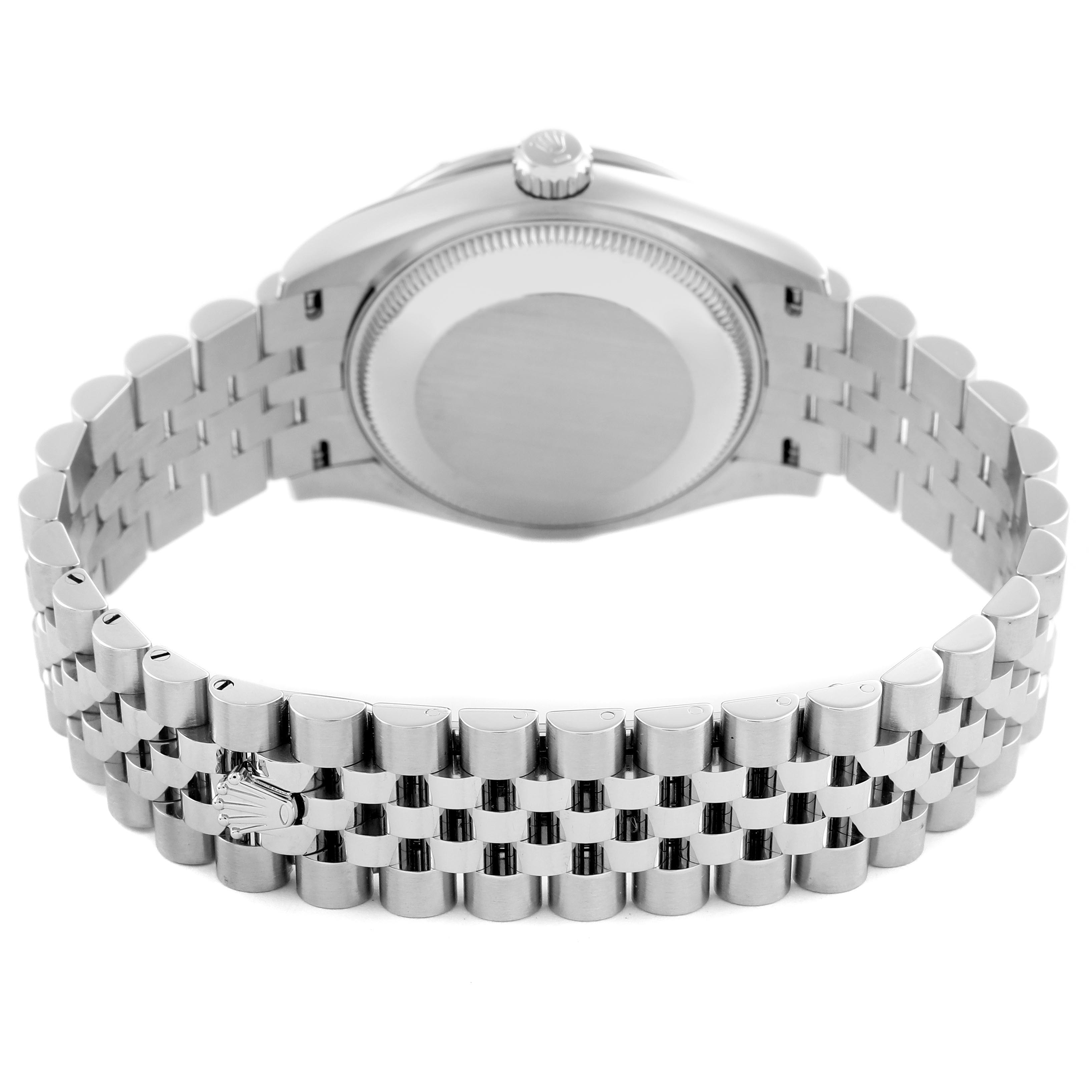 The image shows the back and bracelet of a Rolex Datejust, focusing on the clasp and case back from a slightly elevated angle.