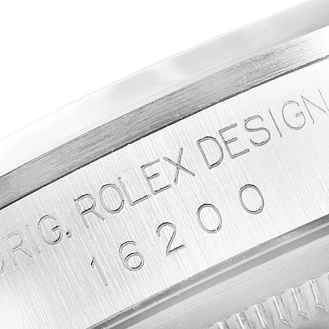 This image shows a close-up view of the engraving on the inner bezel of a Rolex Datejust 16200 Men's Stainless Steel Silver Dial 16200 Men's Stainless Steel Silver Dial model 16200.
