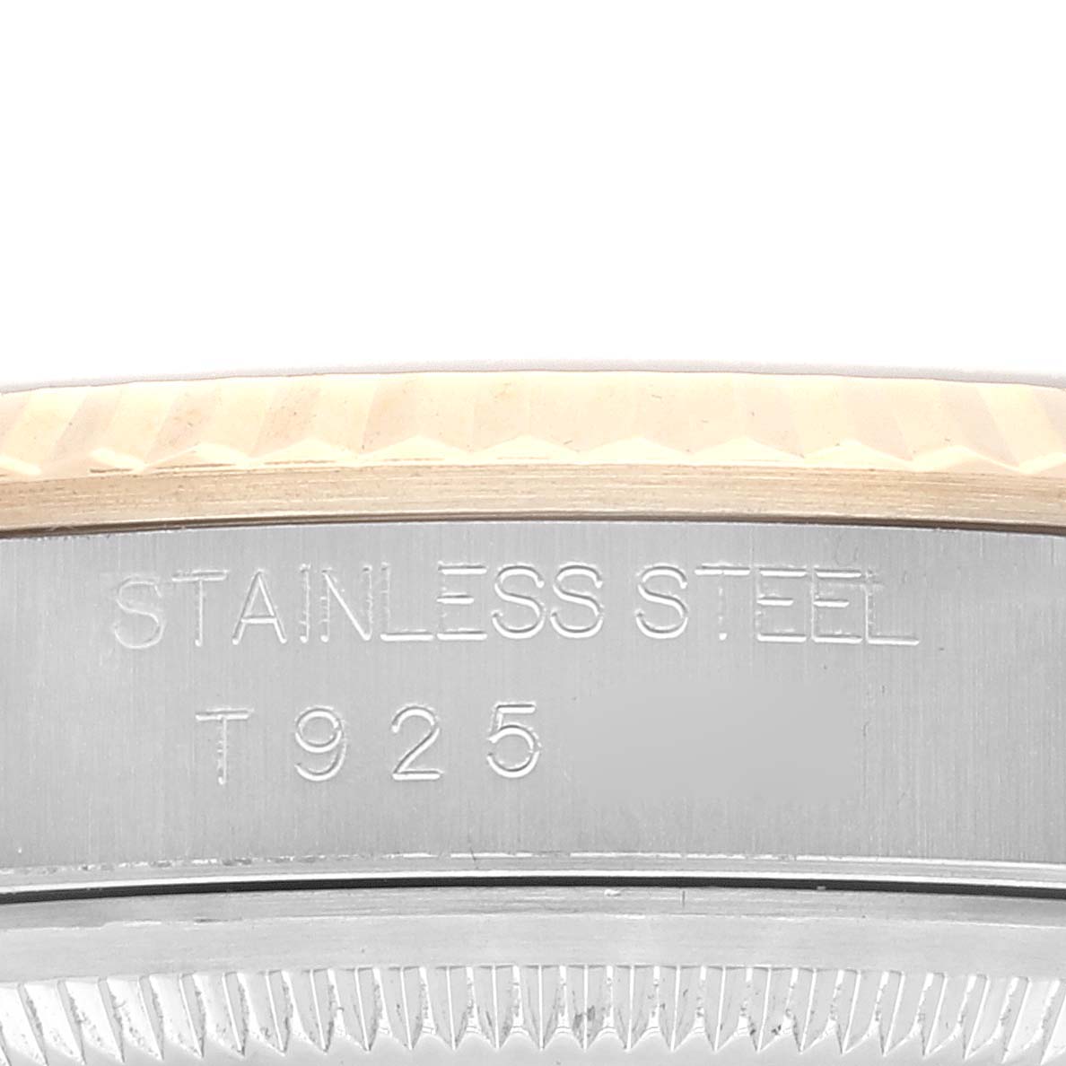 This image shows a close-up view of the engraved side of a Rolex Datejust 16233 Men's Steel and Gold (two tone) Blue Dial 16233 Men's Steel and Gold (two tone) Blue Dial watch case, focusing on the "STAINLESS STEEL" marking.