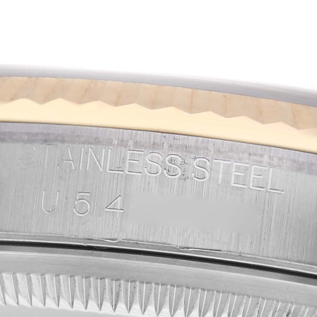 The image shows the side of a Rolex Datejust 16233 Men
s Steel and Gold (two tone) White Dial 16233 Men
s Steel and Gold (two tone) White Dial, highlighting the stainless steel case with engraved details.