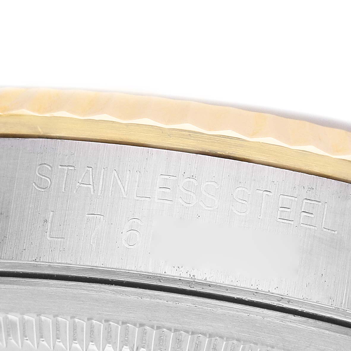 The image shows a close-up of the engraved side of a Rolex Datejust 16233 Men's Steel and Gold (two tone) White Dial's stainless steel case.