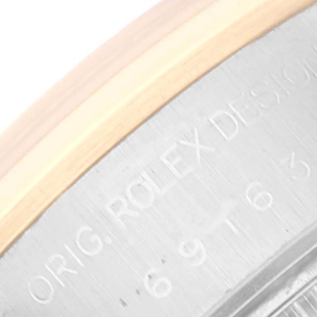 This image shows a close-up of the side casing with engraved text on a Rolex Datejust 69163 Women's Steel and Gold (two tone) Black Dial 69163 Women's Steel and Gold (two tone) Black Dial watch.
