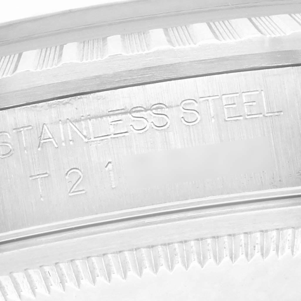 The image shows a close-up of the engravings on the stainless steel side of a Rolex Datejust 16220 Men
s Stainless Steel Black Dial 16220 Men
s Stainless Steel Black Dial, highlighting text and texture.