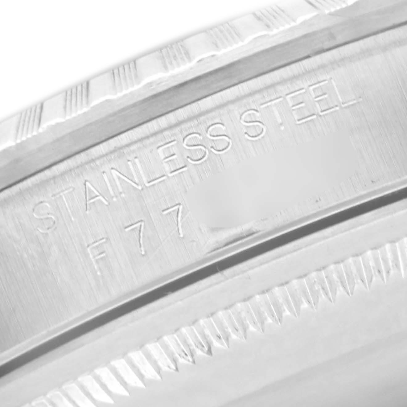 The image shows a close-up of the engraving on the bezel edge of a Rolex Datejust 16220 Men
s Stainless Steel Black Dial 16220 Men
s Stainless Steel Black Dial watch, highlighting the text "STAINLESS STEEL."