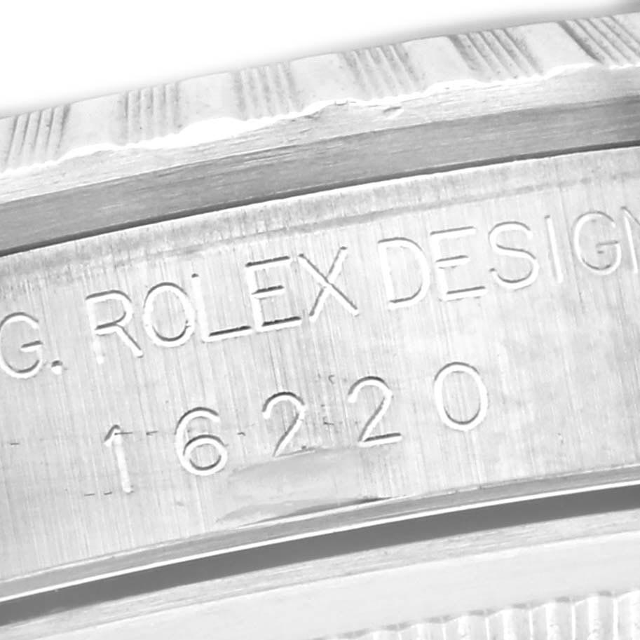 The image shows a close-up of the case
s inner rim on a Rolex Datejust 16220 Men
s Stainless Steel Black Dial 16220 Men
s Stainless Steel Black Dial, highlighting engraved details.