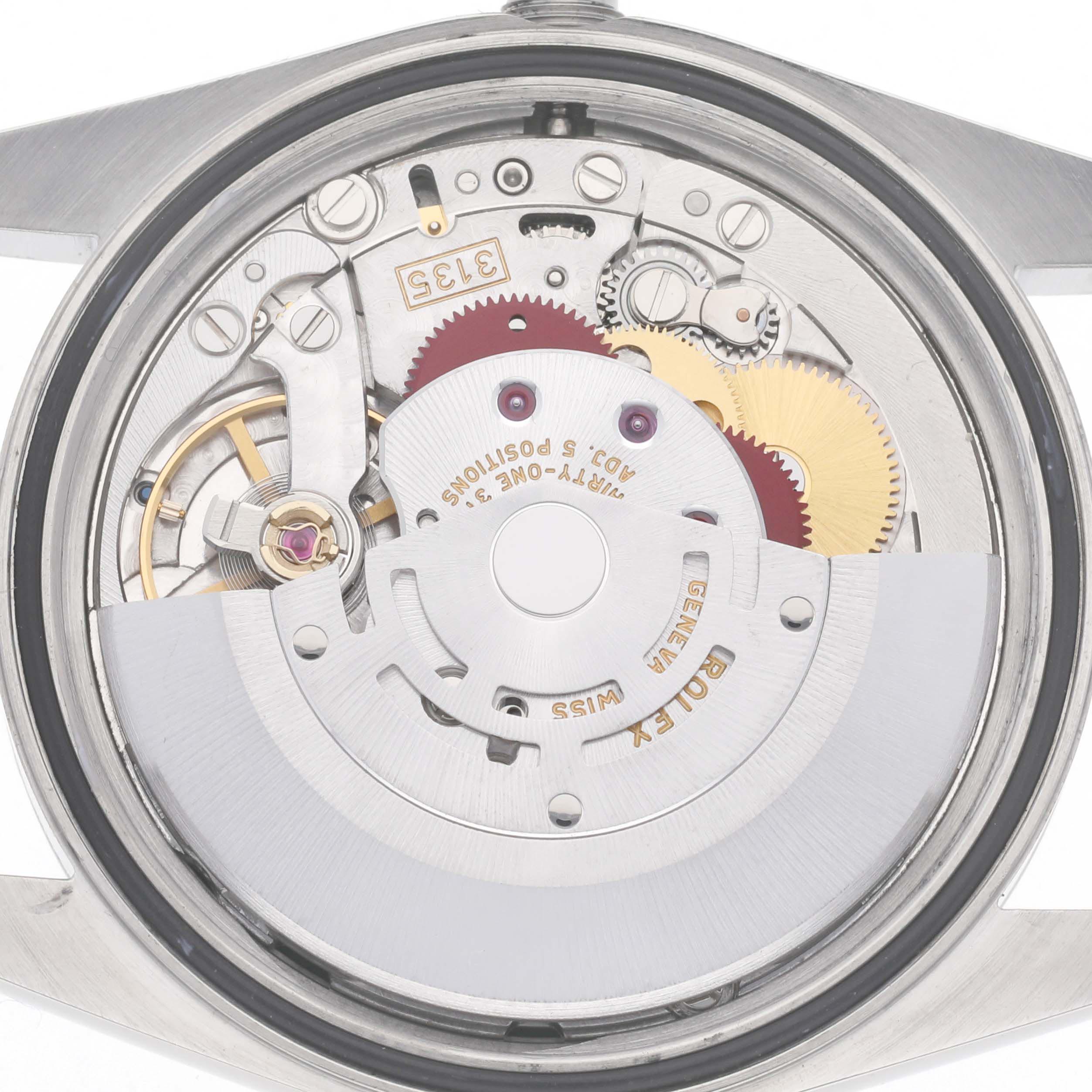 The image shows the back view of a Rolex Datejust 16220 Men
s Stainless Steel Black Dial 16220 Men
s Stainless Steel Black Dial, focusing on its intricate movement mechanisms.