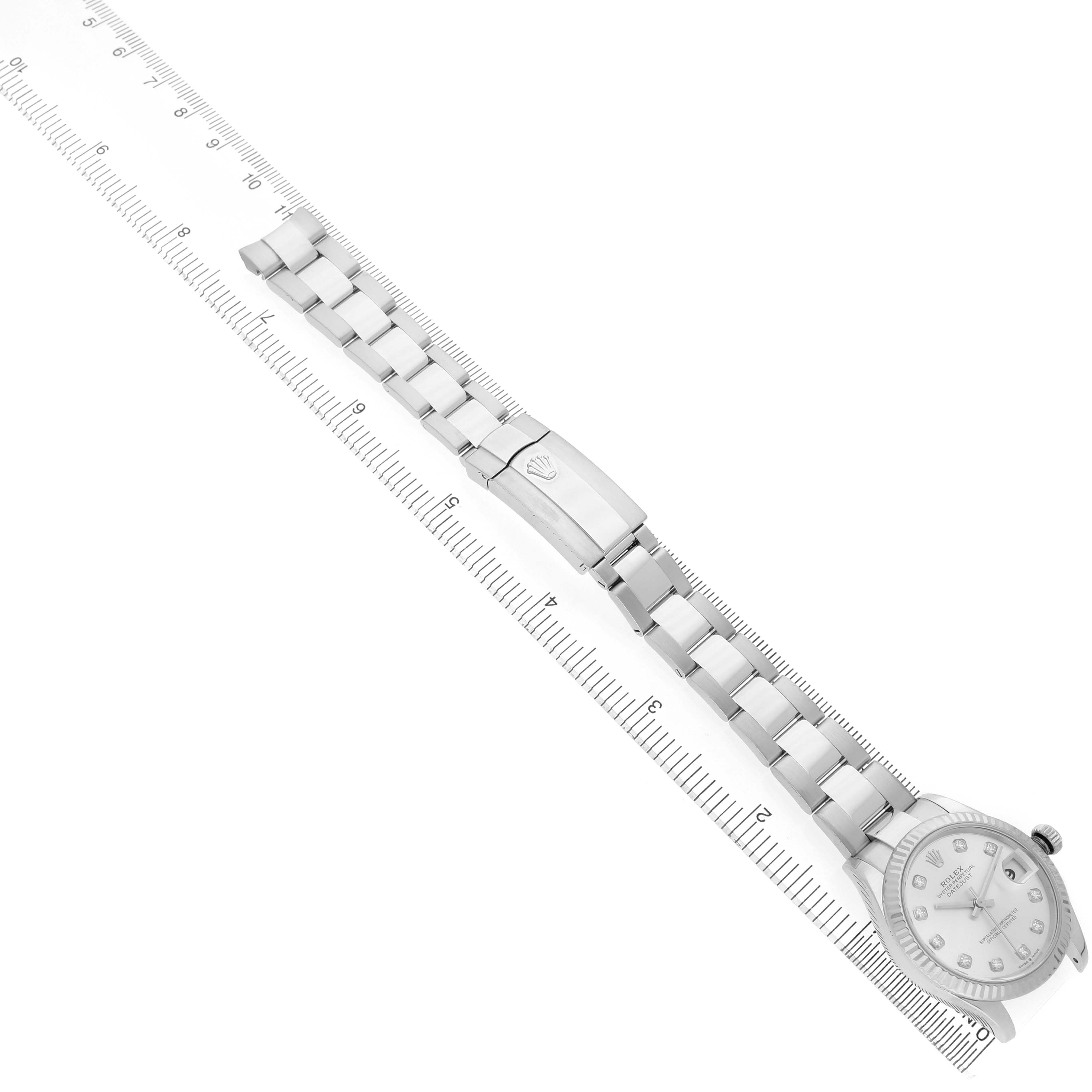 The image shows a Rolex Datejust 278274 Men's Stainless Steel Silver Dial watch laid flat with full view of the bracelet, clasp, and face, positioned alongside a ruler.