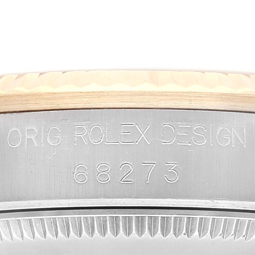 This close-up image shows the engraved case side with 
ORIG ROLEX DESIGN
 and model number 68273 of a Mid-Size Rolex watch.