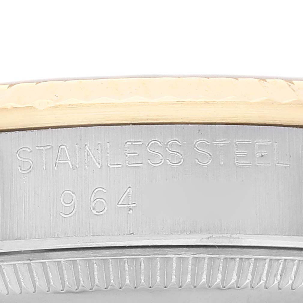 The image shows a close-up of the stainless steel case back and edge of the bezel of a Rolex Mid-Size 68273 Women's Stainless Steel Champagne Dial 68273 Women's Stainless Steel Champagne Dial model.