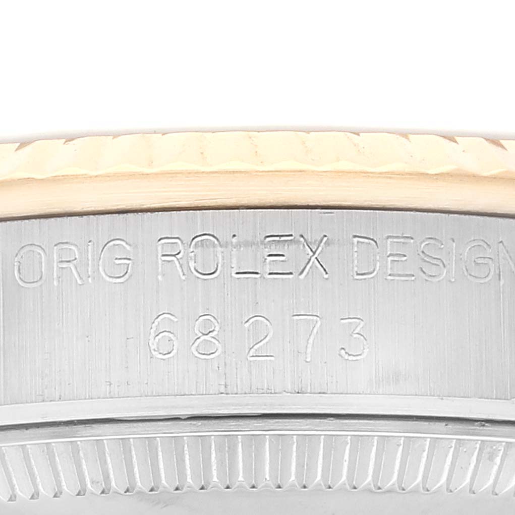This close-up image shows the engraved model number "68273" and part of the bezel of a Mid-Size Rolex watch.