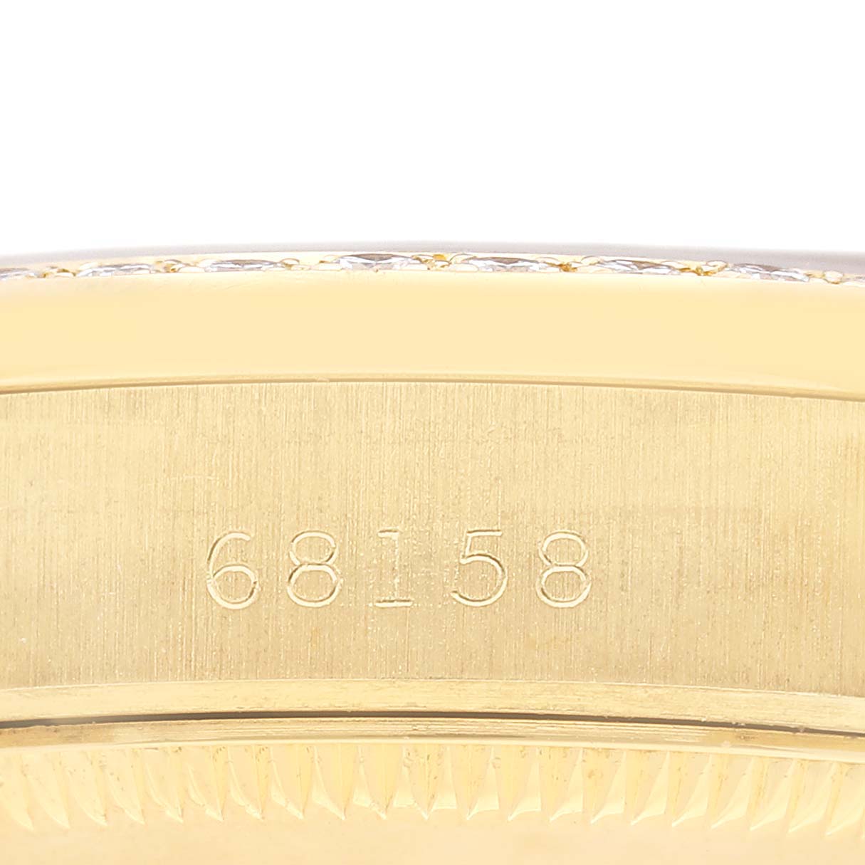 The image shows the side engraved with "68158" on the Rolex President 68158 Women's Yellow Gold Champagne Dial model's case.