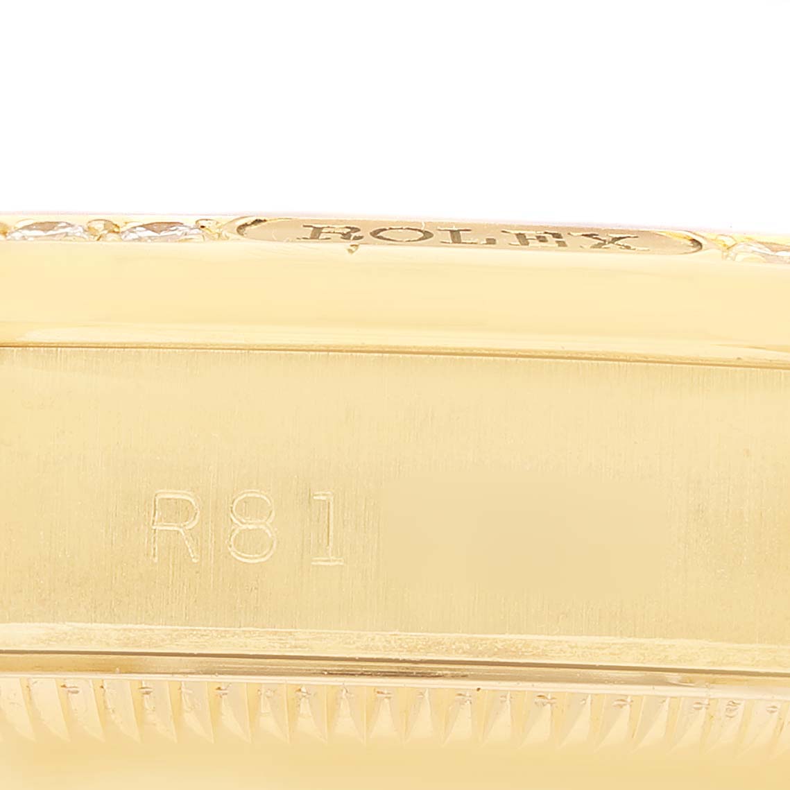The image shows a close-up of the side case and bezel of a Rolex President 68158 Women's Yellow Gold Champagne Dial model, highlighting the engraving details.