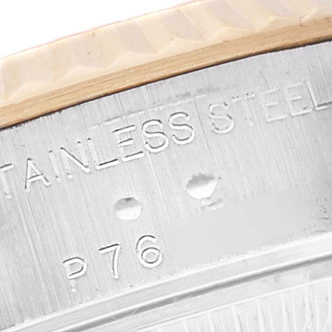 This image shows a close-up of the engraved serial number and "STAINLESS STEEL" inscription on a Rolex Datejust 79173 Women's Steel and Gold (two tone) Silver Dial 79173 Women's Steel and Gold (two tone) Silver Dial watch's case.