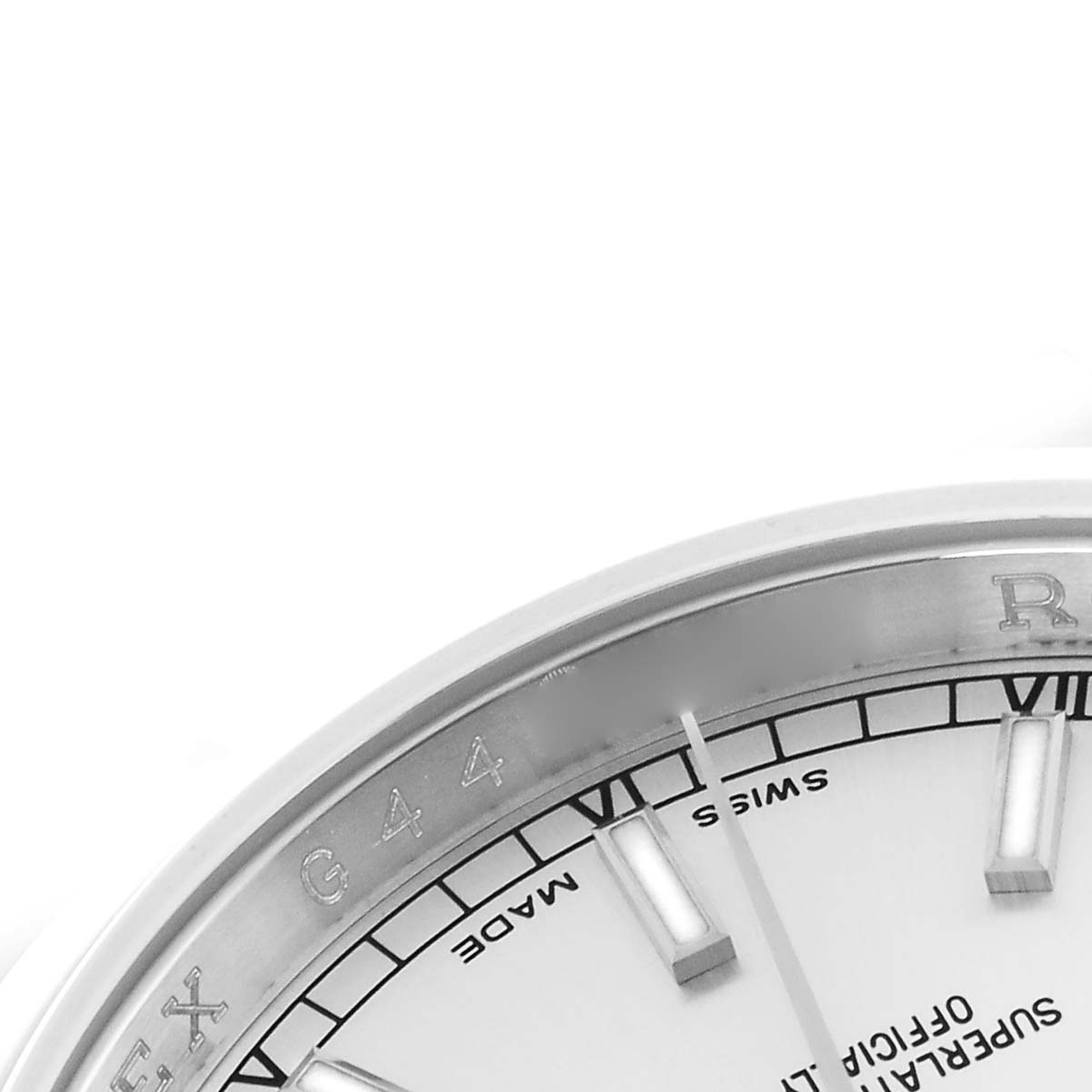 The image shows a close-up of the dial and rehaut of a Rolex Datejust 116200 Men's Stainless Steel Silver Dial 116200 Men's Stainless Steel Silver Dial, featuring hour markers and parts of inscriptions.