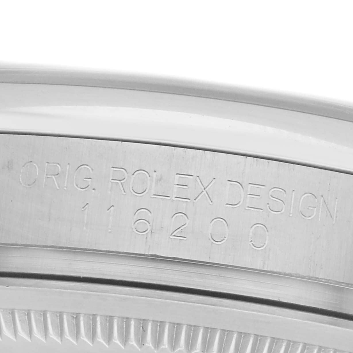 The image shows a close-up angle of the engraved case side of a Rolex Datejust 116200 Men's Stainless Steel Silver Dial 116200 Men's Stainless Steel Silver Dial watch, featuring the model number.