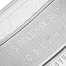 This image shows a close-up of the inner casing of a Rolex Datejust 69174 Women's Stainless Steel Silver Dial 69174 Women's Stainless Steel Silver Dial model, displaying its design and serial numbers.