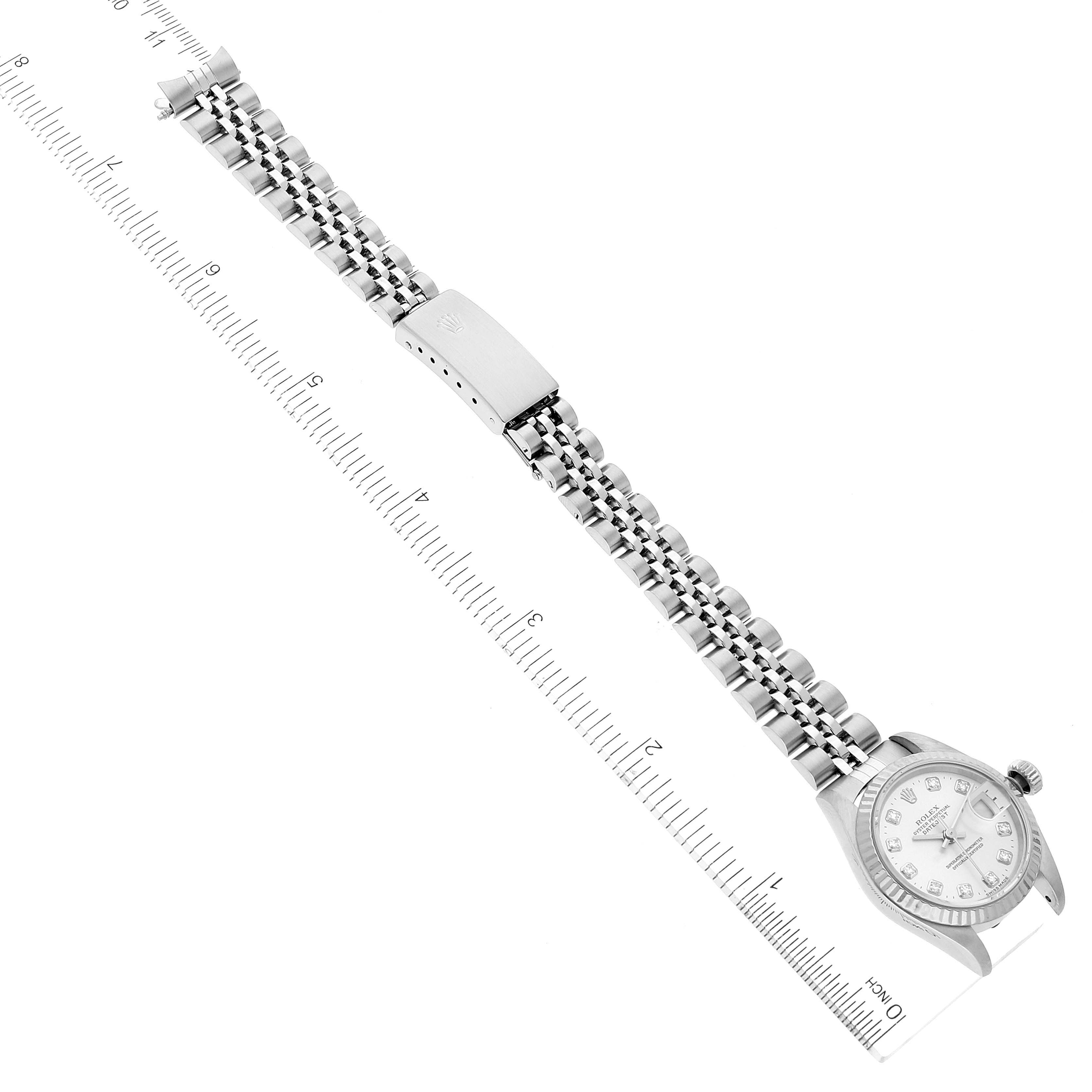 The image shows a Rolex Datejust 69174 Women's Stainless Steel Silver Dial 69174 Women's Stainless Steel Silver Dial watch placed flat with its bracelet fully extended alongside a ruler for scale.