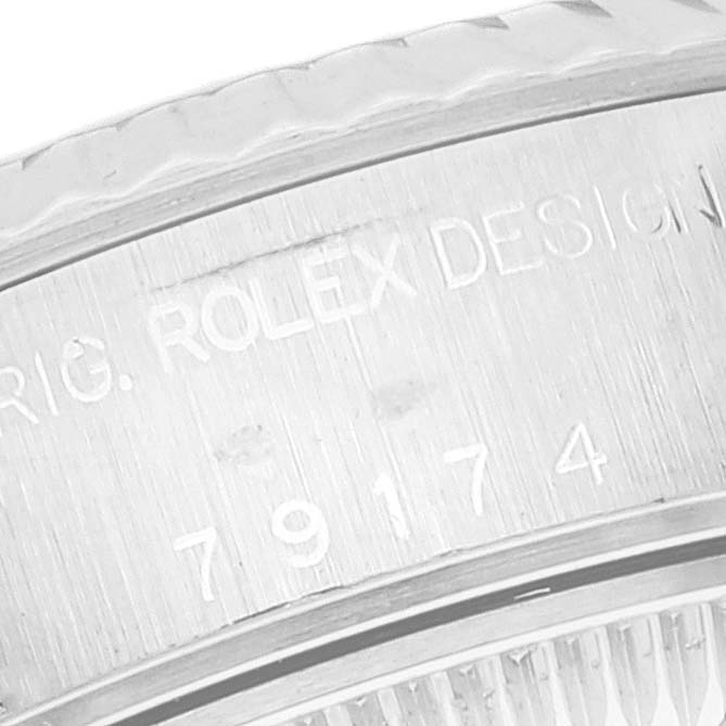 This image shows a close-up of the bezel and casing edge with the serial number of a Rolex Datejust 79174 Women's Stainless Steel Mother of Pearl Dial 79174 Women's Stainless Steel Mother of Pearl Dial.