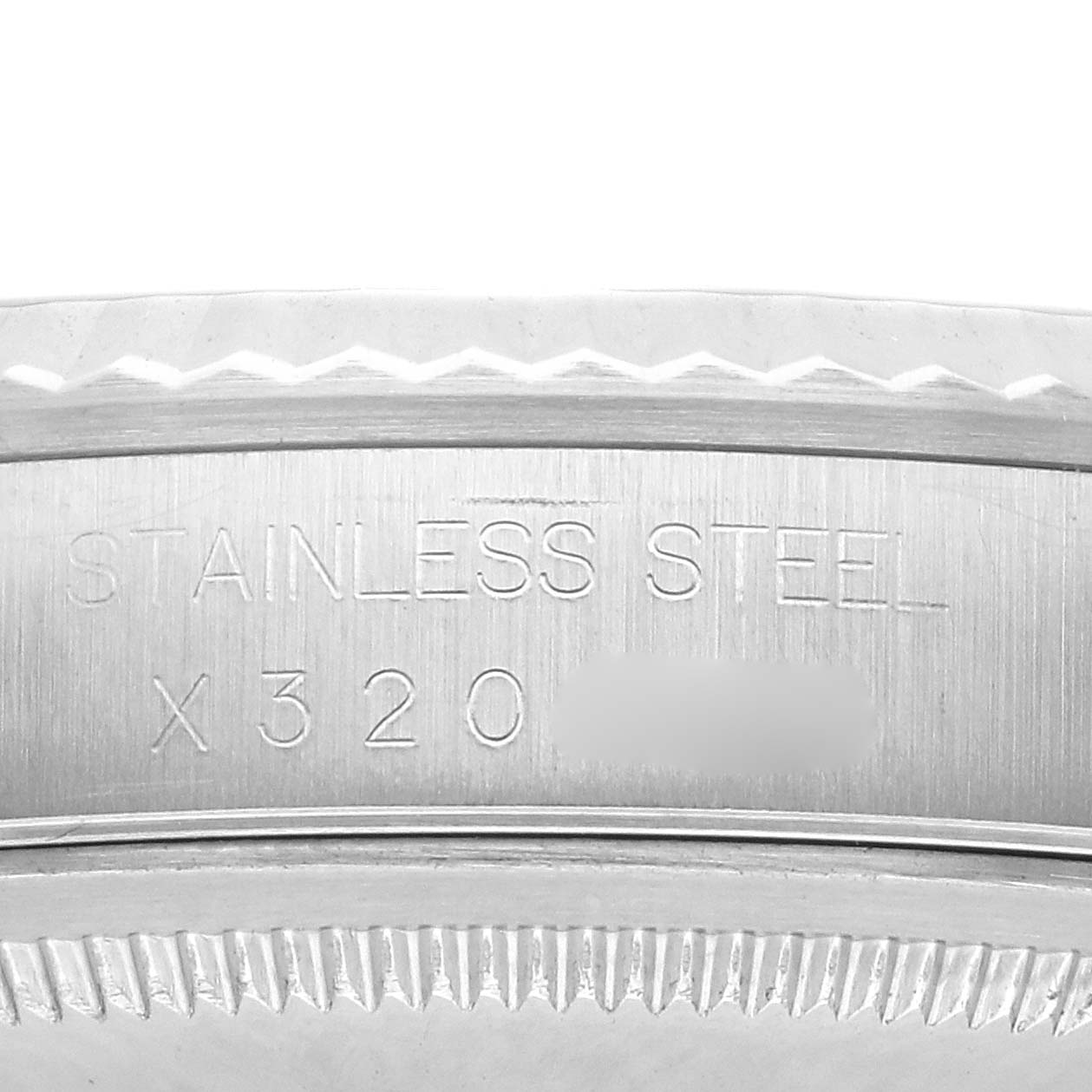 The image shows a close-up of the Rolex Datejust 16234 Men
s Stainless Steel Silver Dial 16234 Men
s Stainless Steel Silver Dial case back with engraved text, focusing on the stainless steel and serial number.