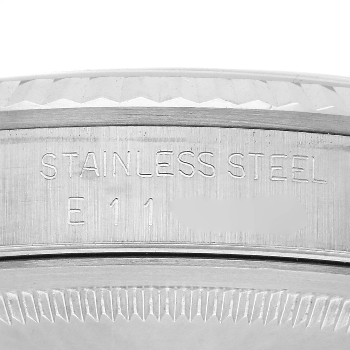 The image shows a close-up of a Rolex Datejust 16234 Men
s Stainless Steel Silver Dial 16234 Men
s Stainless Steel Silver Dial stainless steel case with engraved detailing.