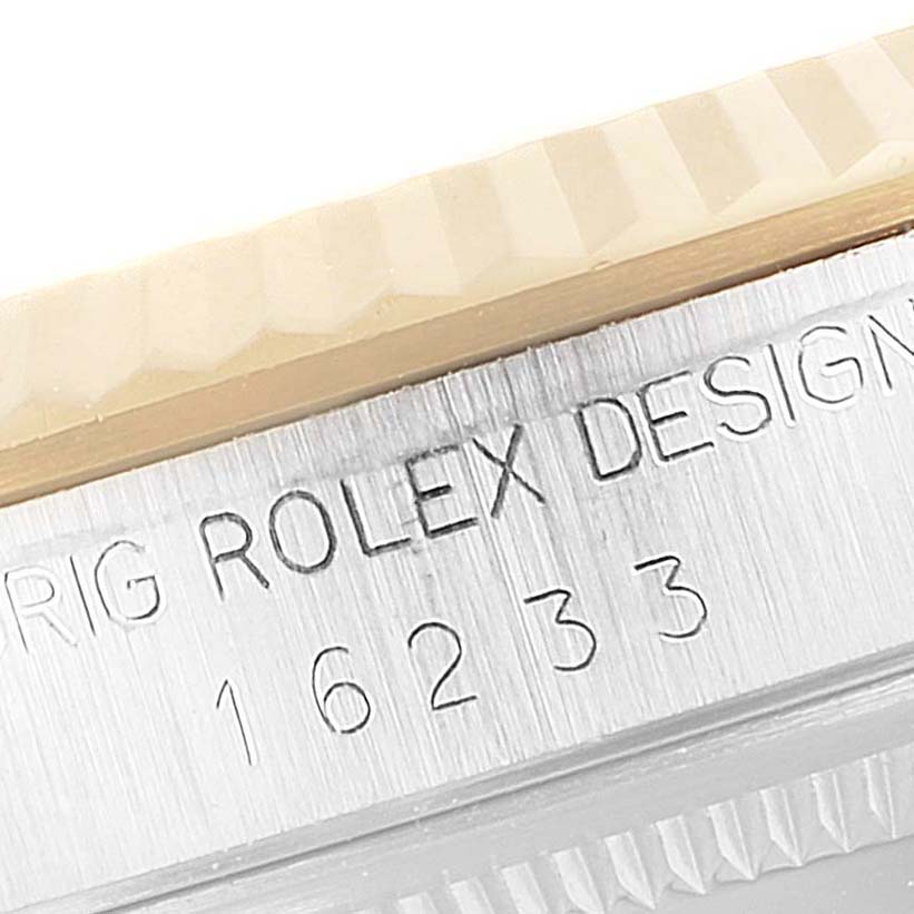 This close-up image shows the engraved case with the model number of a Rolex Datejust 16233 Men's Steel and Gold (two tone) Blue Dial 16233 Men's Steel and Gold (two tone) Blue Dial watch.