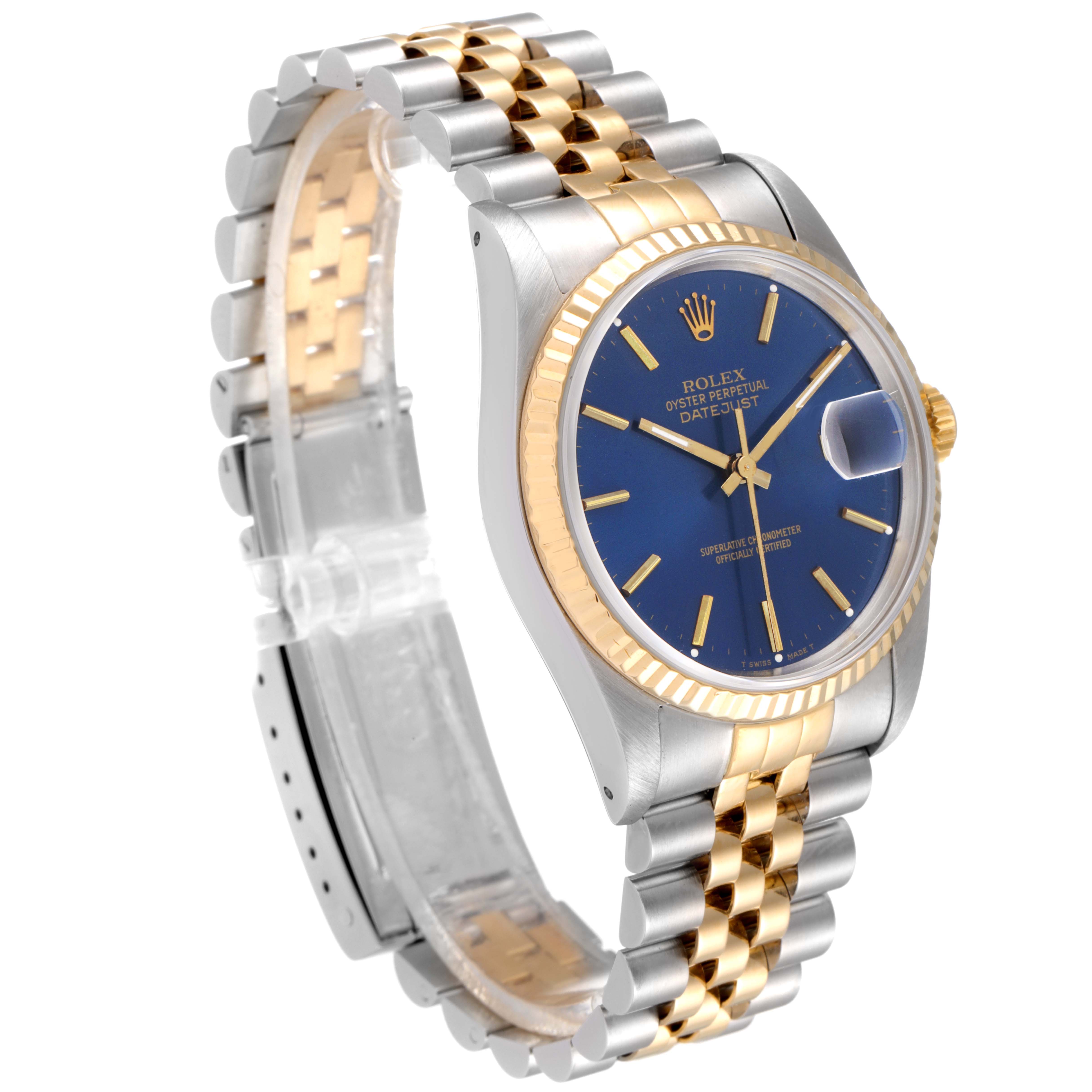 Displayed at an angle, the Rolex Datejust 16233 Men's Steel and Gold (two tone) Blue Dial 16233 Men's Steel and Gold (two tone) Blue Dial watch features its steel and gold bracelet, blue dial, and fluted bezel.