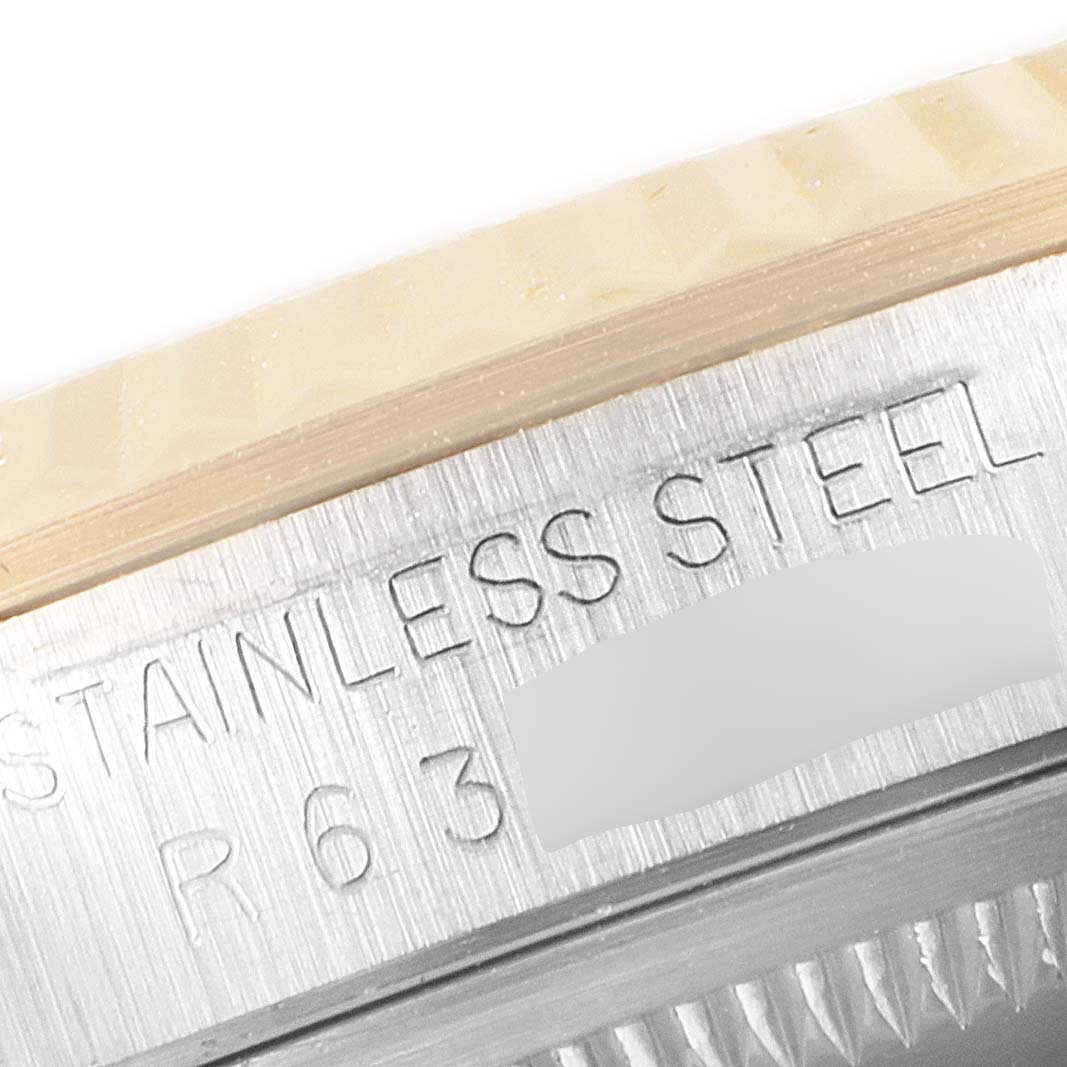 The image shows a close-up of the stainless steel case back engraving on a Rolex Datejust 16233 Men's Steel and Gold (two tone) Blue Dial 16233 Men's Steel and Gold (two tone) Blue Dial watch.