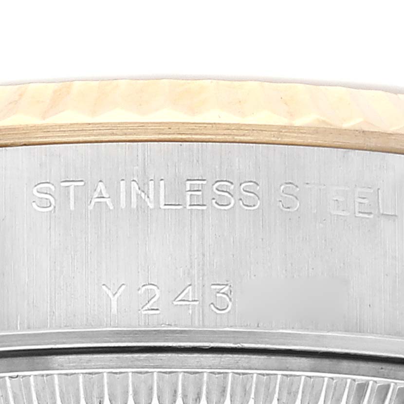 The image shows a close-up of the Rolex Datejust 79173 Women's Steel and Gold (two tone) Champagne Dial 79173 Women's Steel and Gold (two tone) Champagne Dial watch case, highlighting the stainless steel material and part of the serial number.