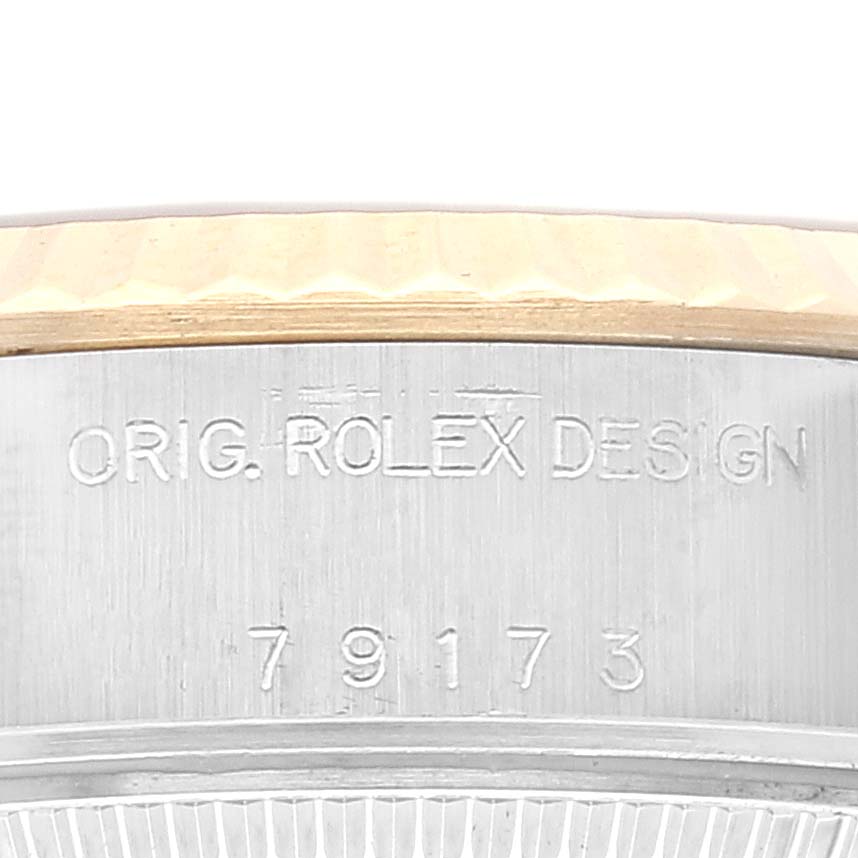 This close-up image shows the case edge of a Rolex Datejust 79173 Women's Steel and Gold (two tone) Champagne Dial 79173 Women's Steel and Gold (two tone) Champagne Dial, featuring the "ORIG. ROLEX DESIGN" engraving and model number 79173.