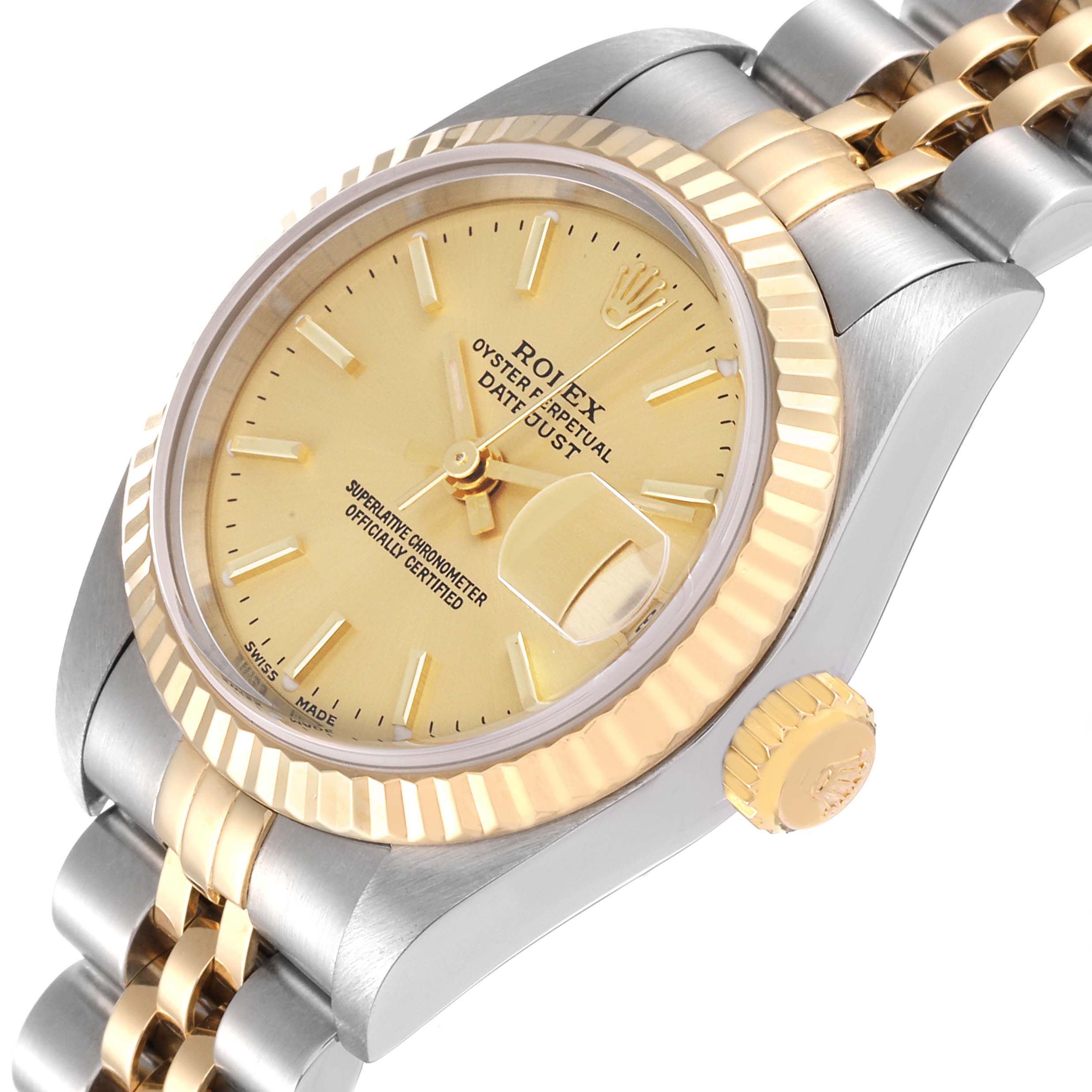 The image shows an angled view of a Rolex Datejust 79173 Women's Steel and Gold (two tone) Champagne Dial 79173 Women's Steel and Gold (two tone) Champagne Dial watch with a gold and silver bracelet, along with the crown and dial.