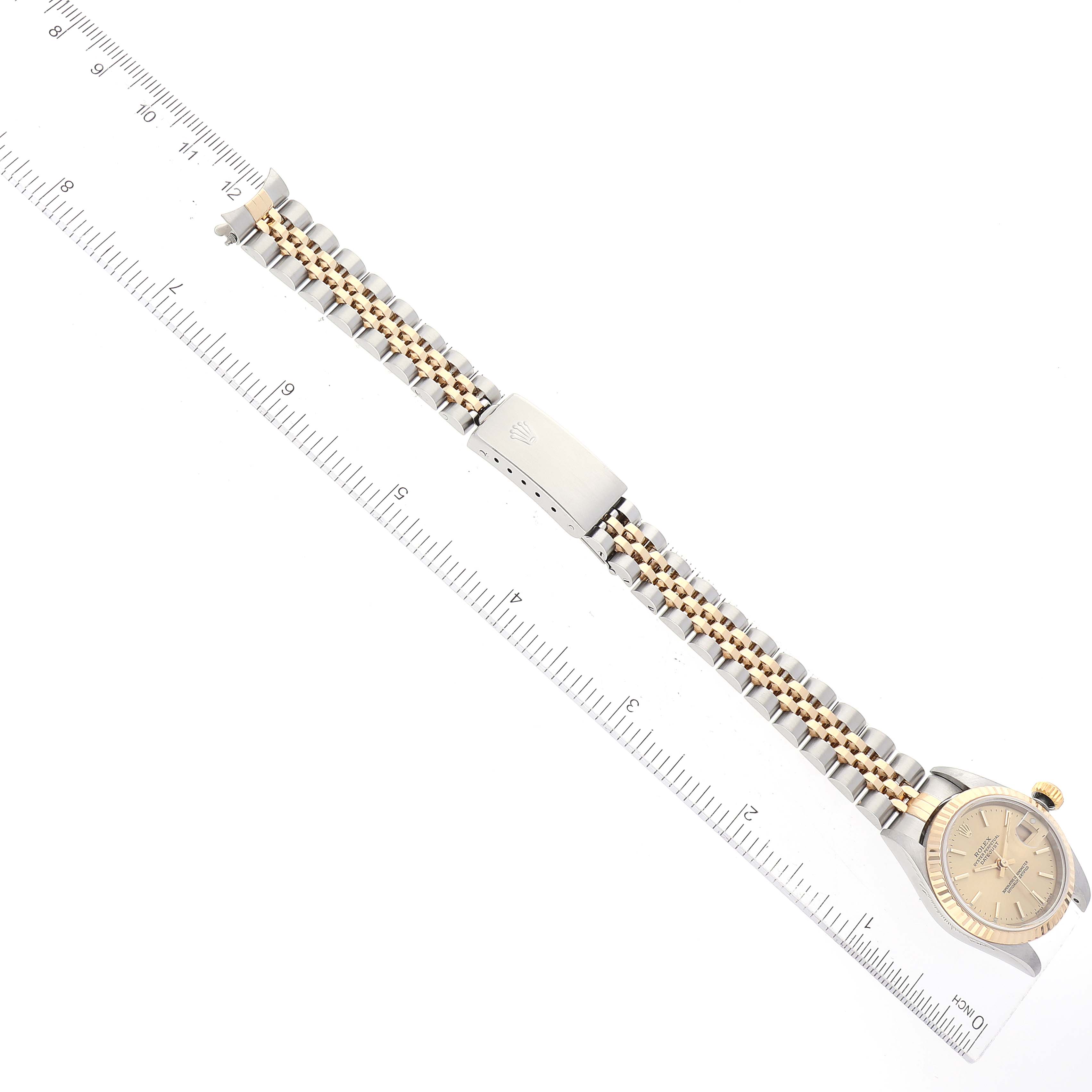 This image shows a Rolex Datejust 79173 Women's Steel and Gold (two tone) Champagne Dial 79173 Women's Steel and Gold (two tone) Champagne Dial watch with a full view of its bracelet and the clasp measured with a ruler.