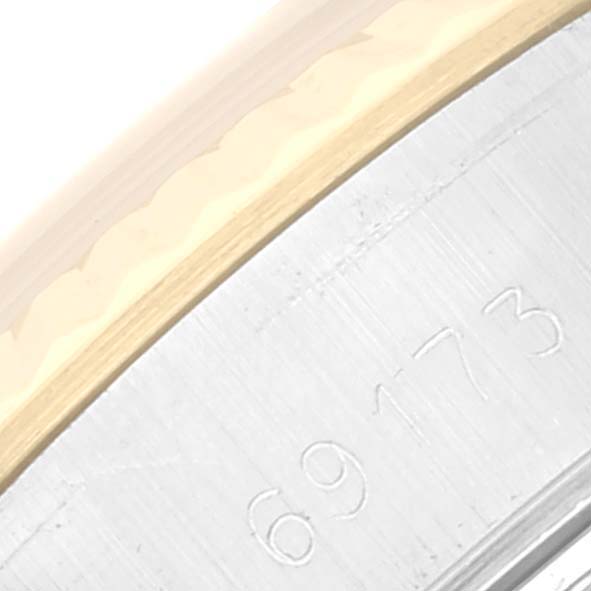 This close-up image shows the serial number engraved on the case of a Rolex Datejust 69173 Women's Steel and Gold (two tone) Champagne Dial 69173 Women's Steel and Gold (two tone) Champagne Dial watch.