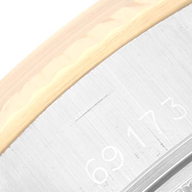 The image shows a close-up angle of the Rolex Datejust 69173 Women's Steel and Gold (two tone) Champagne Dial 69173 Women's Steel and Gold (two tone) Champagne Dial, focusing on part of the bezel and the engraved model number on the metal.