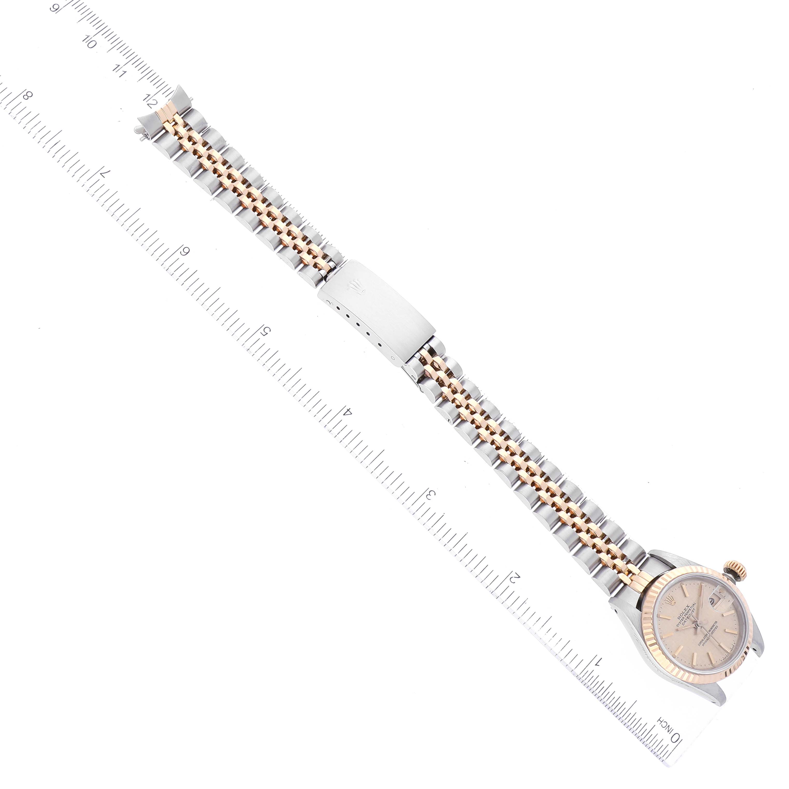 The image shows a Rolex Datejust 69173 Women's Steel and Gold (two tone) Champagne Dial 69173 Women's Steel and Gold (two tone) Champagne Dial watch from a top-down angle, highlighting the face, bezel, bracelet, and clasp against a measuring ruler.