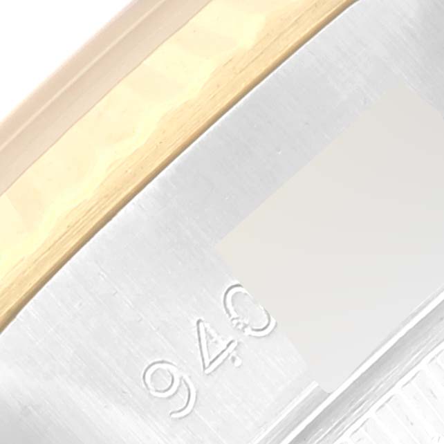 This close-up image shows the bezel and part of the caseback of the Rolex Datejust 69173 Women's Steel and Gold (two tone) Champagne Dial 69173 Women's Steel and Gold (two tone) Champagne Dial watch, featuring the engraved number "940".